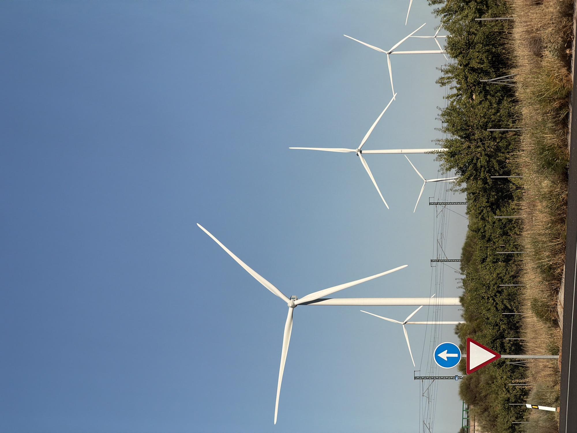 Highway scene near Motilla del Palancar with wind turbines in view