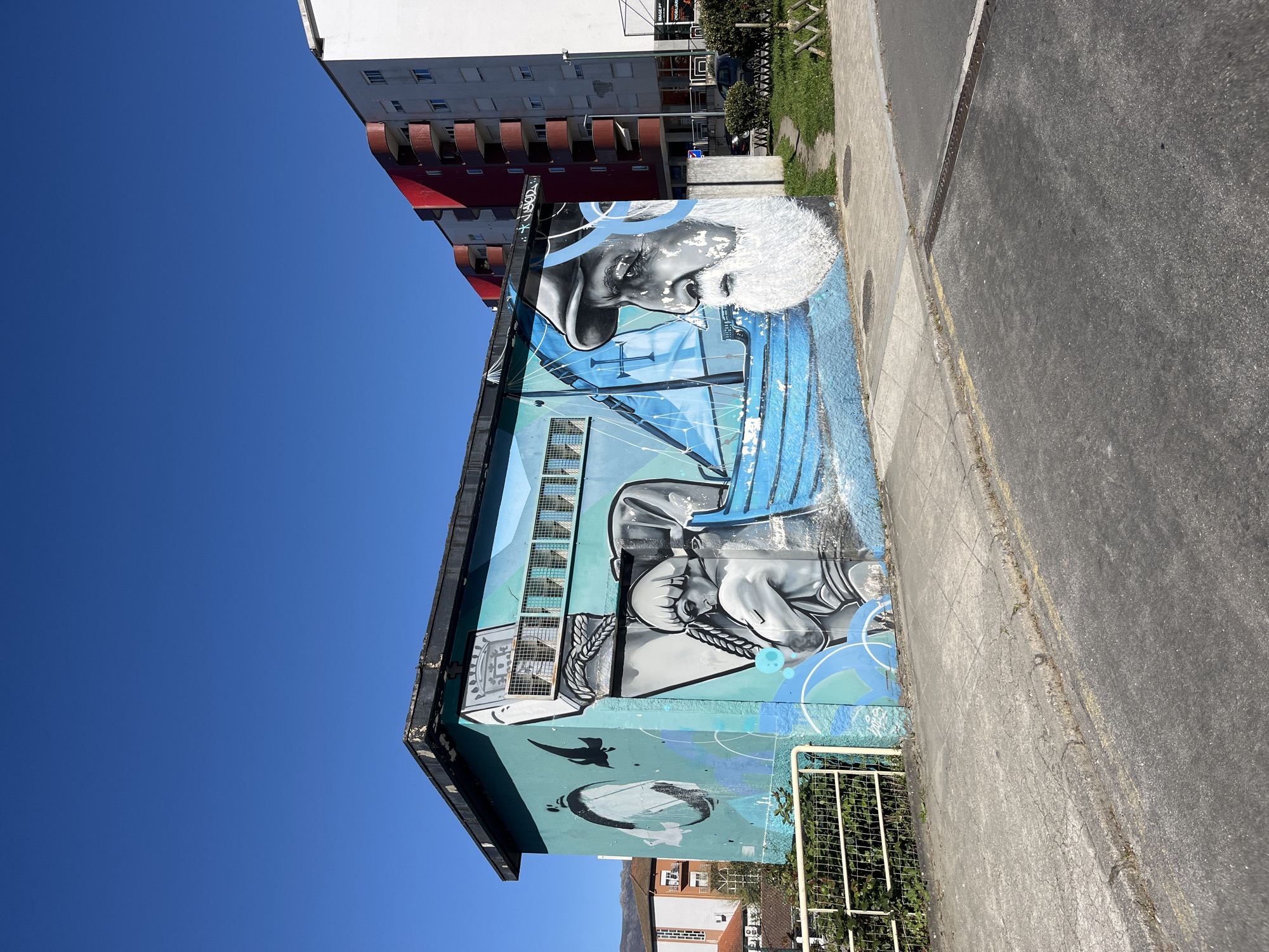 Building mural featuring elderly pipe smoker spotted in Vila Real