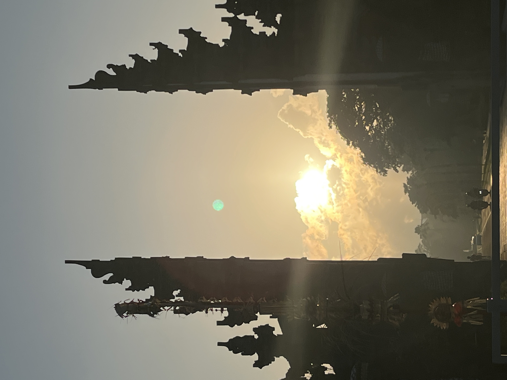 Balinese split gate silhouetted against a golden sky