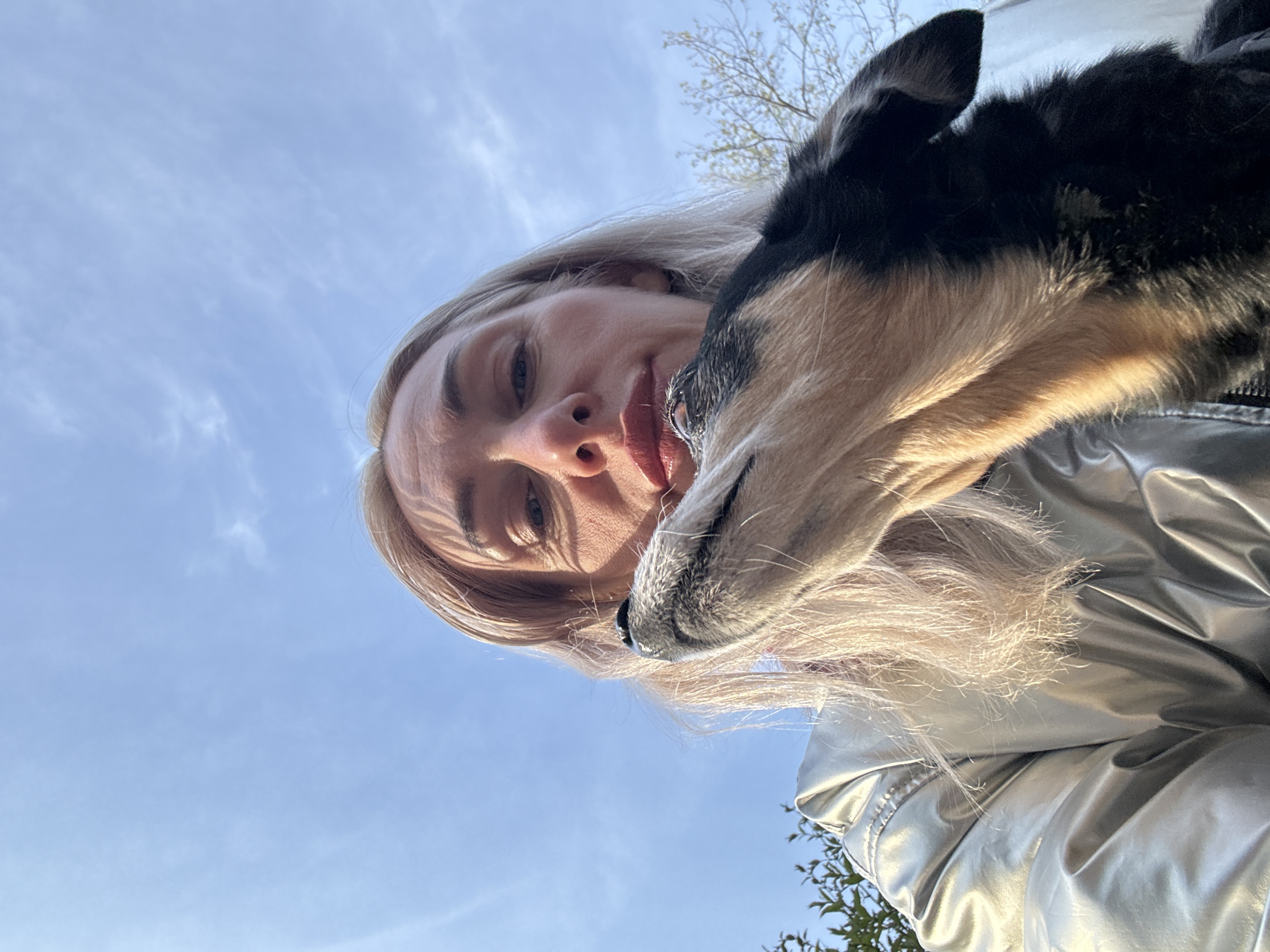 Woman photographs with dog and doll in Saint Petersburg park