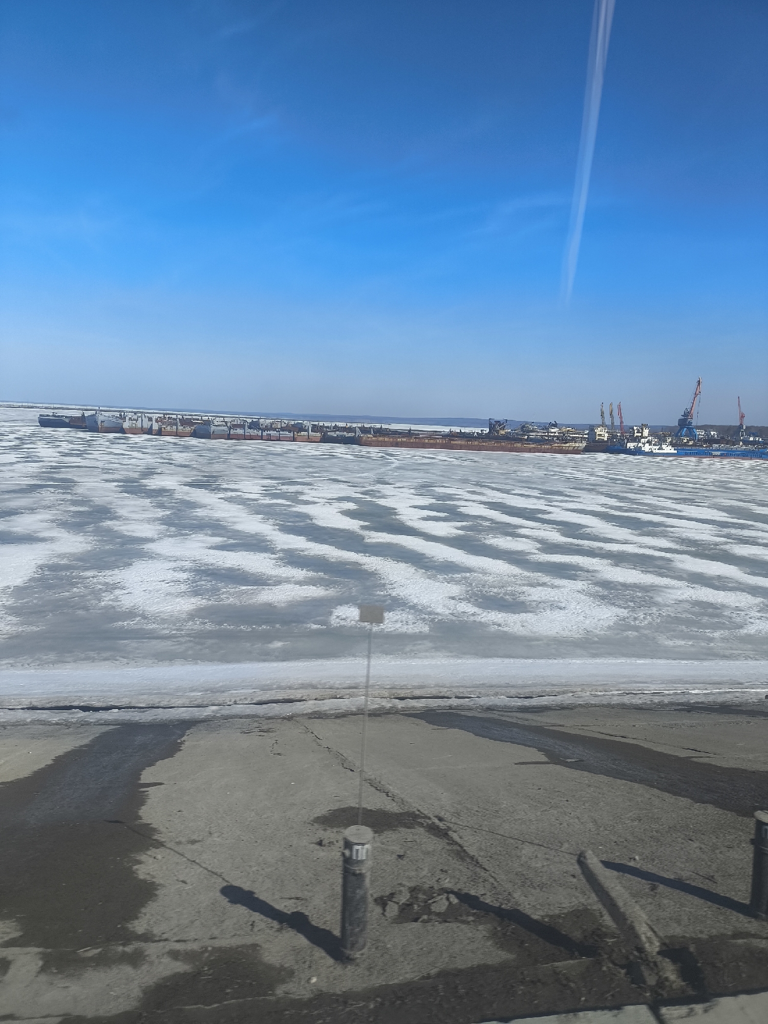 Ship docked at frozen harbor in Chaikovsky, Russia