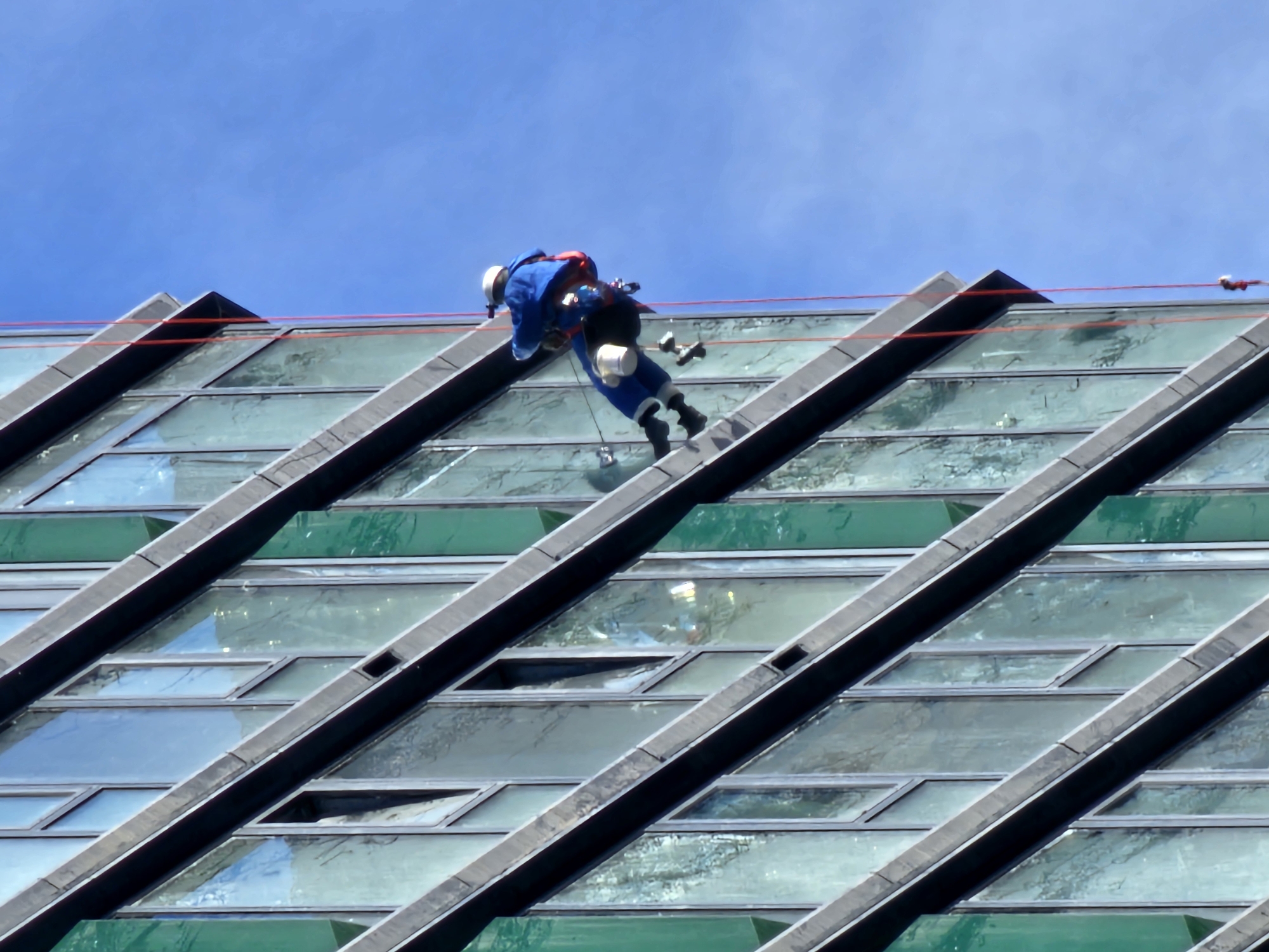 Window washer rappels down Moscow building during daytime