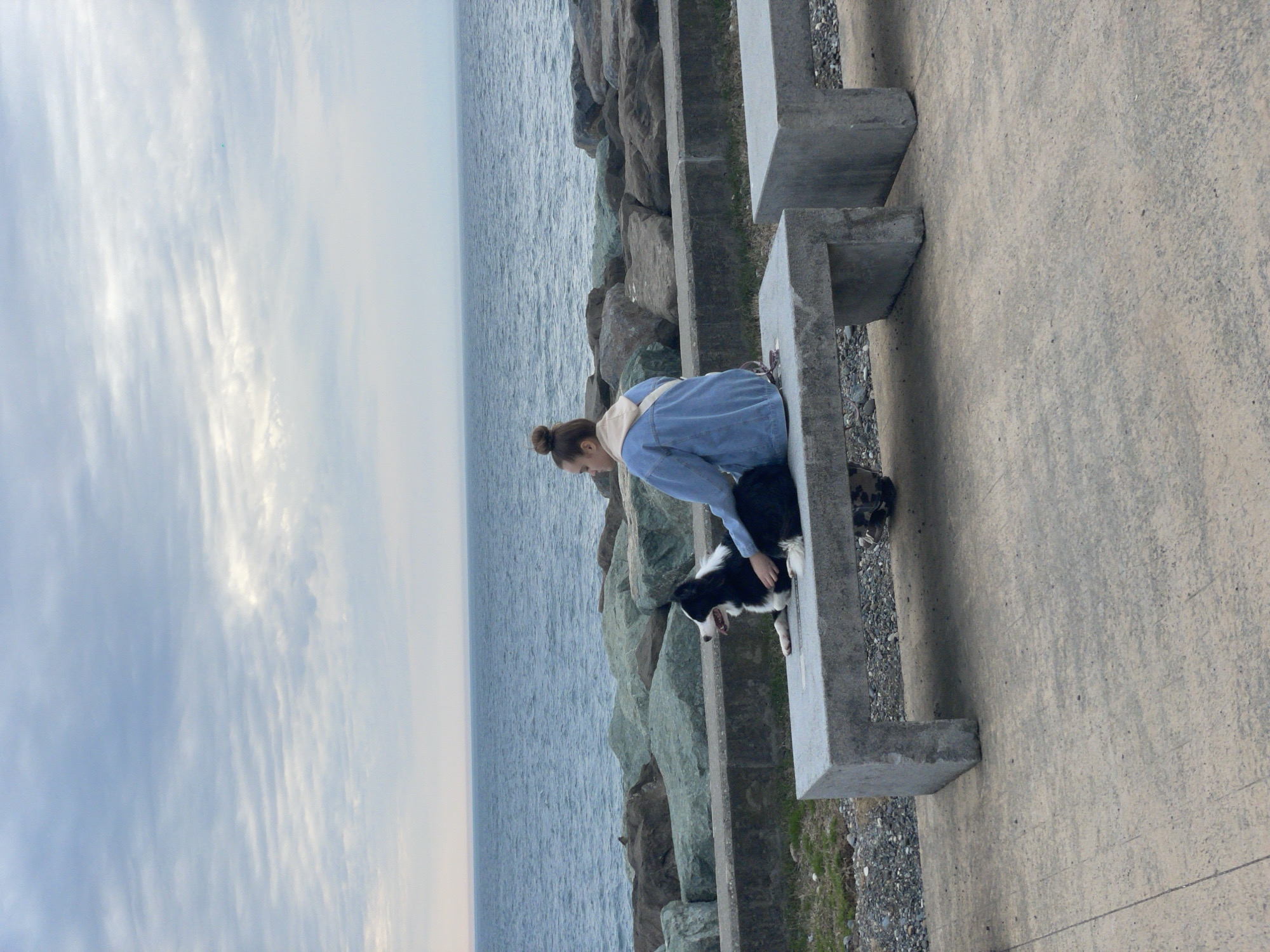 Woman relaxes with dog on Batumi coastline