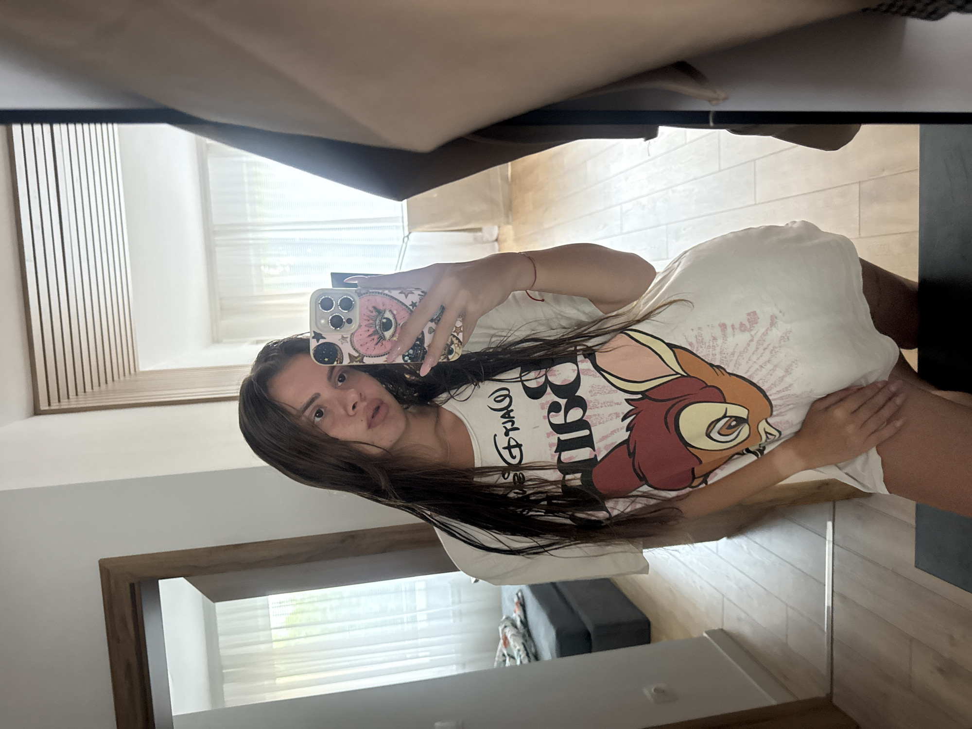 Woman documents lazy afternoon in Disney shirt, Plovdiv
