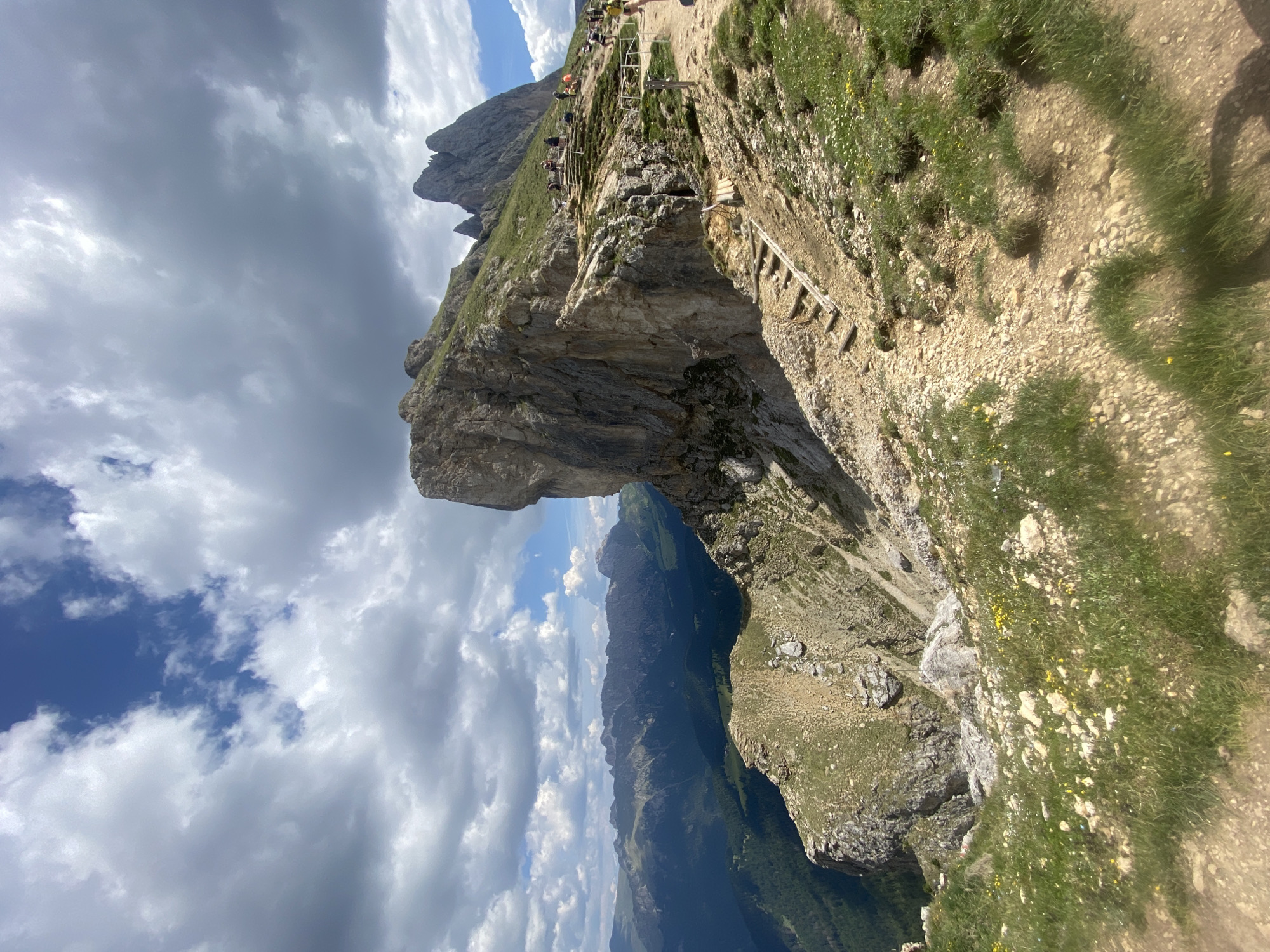 Morning hike through the Dolomites, cliffs and wildflower meadows