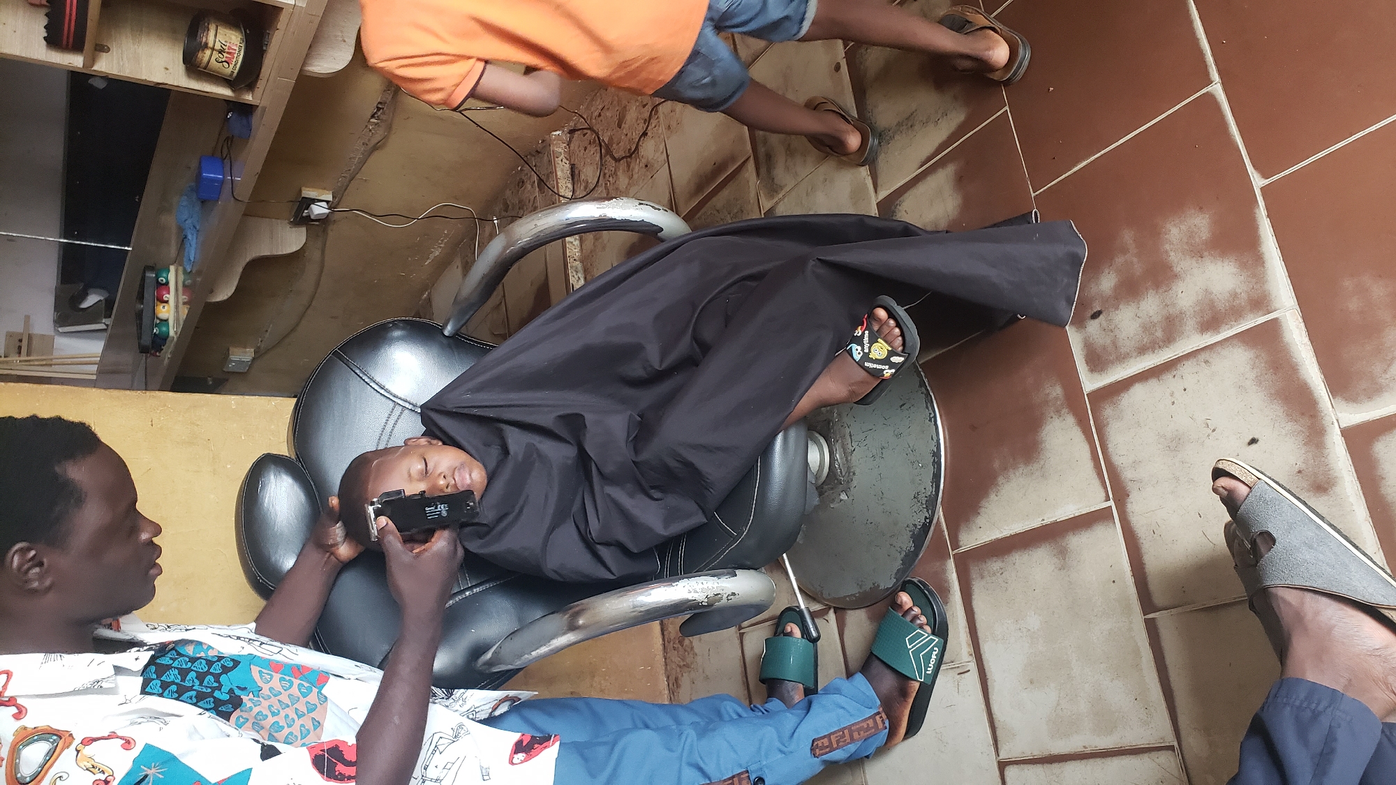 Child gets haircut at Narayi barbershop