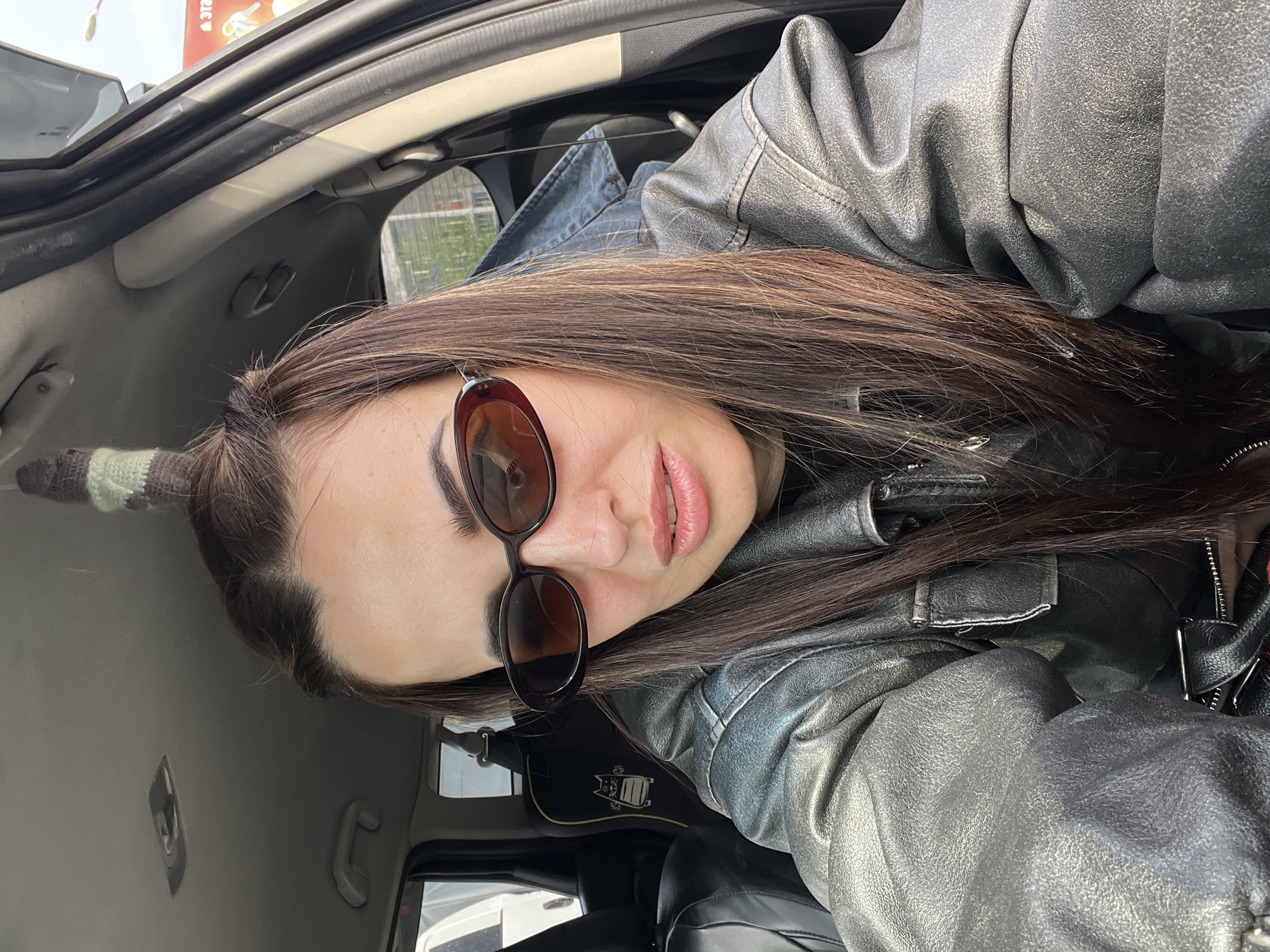 Woman in leather jacket spotted in car with skull candle