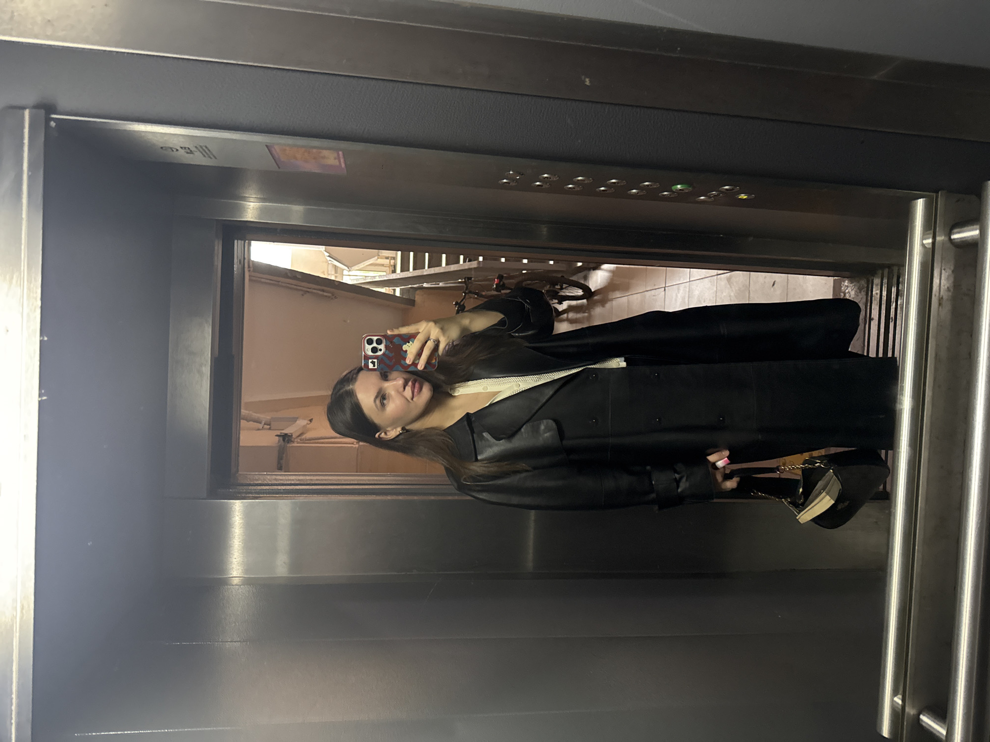 Woman takes early morning elevator selfie in Moscow