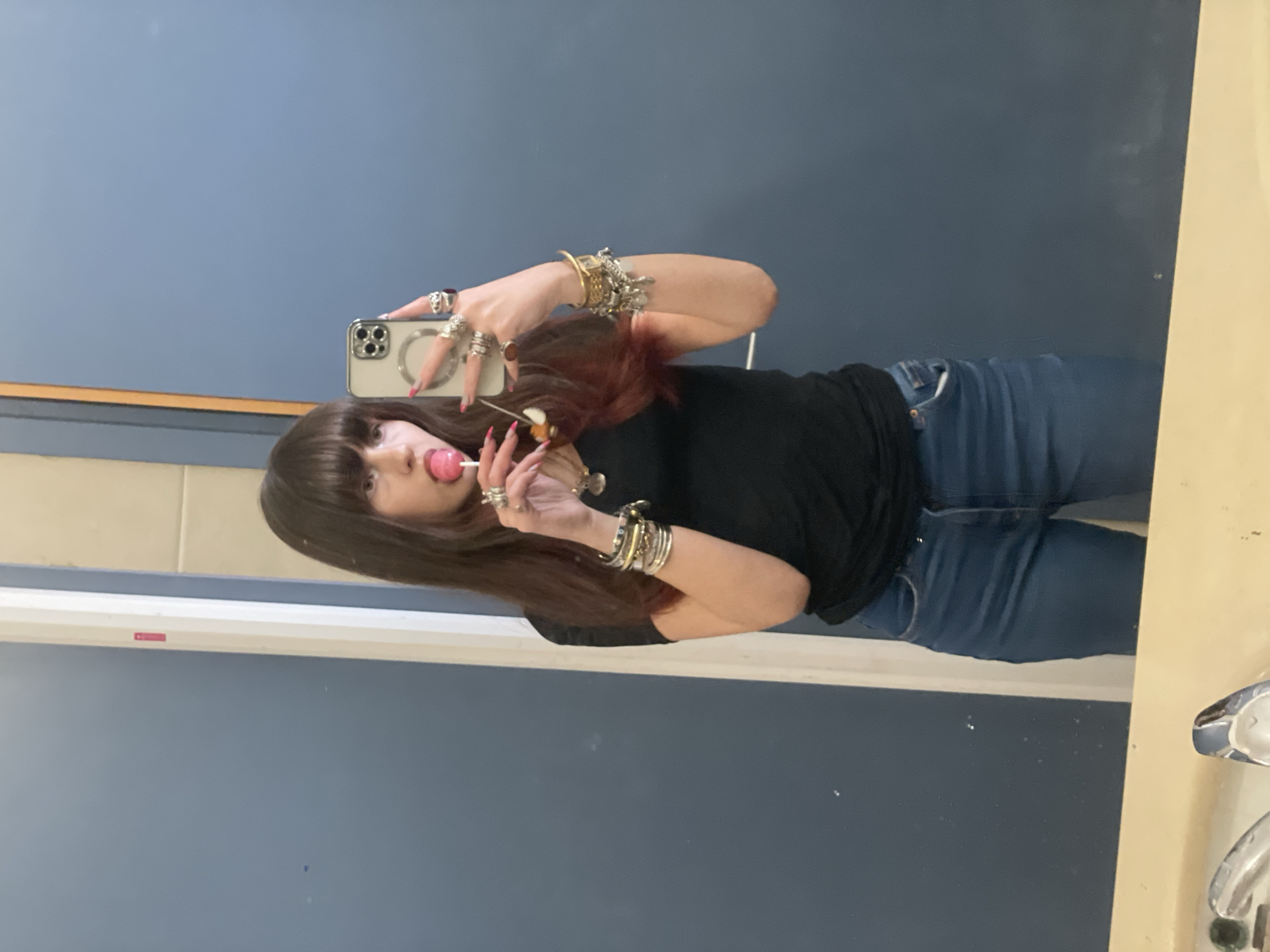 Woman takes bathroom selfie with lollipop in Raanana