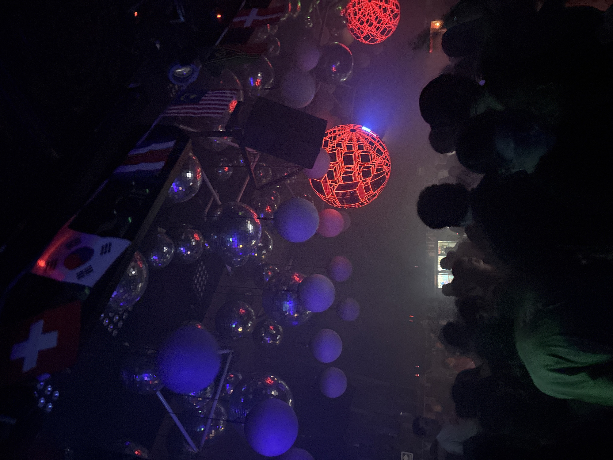 Smoky nightclub scene in Veracruz with disco balls and crowds
