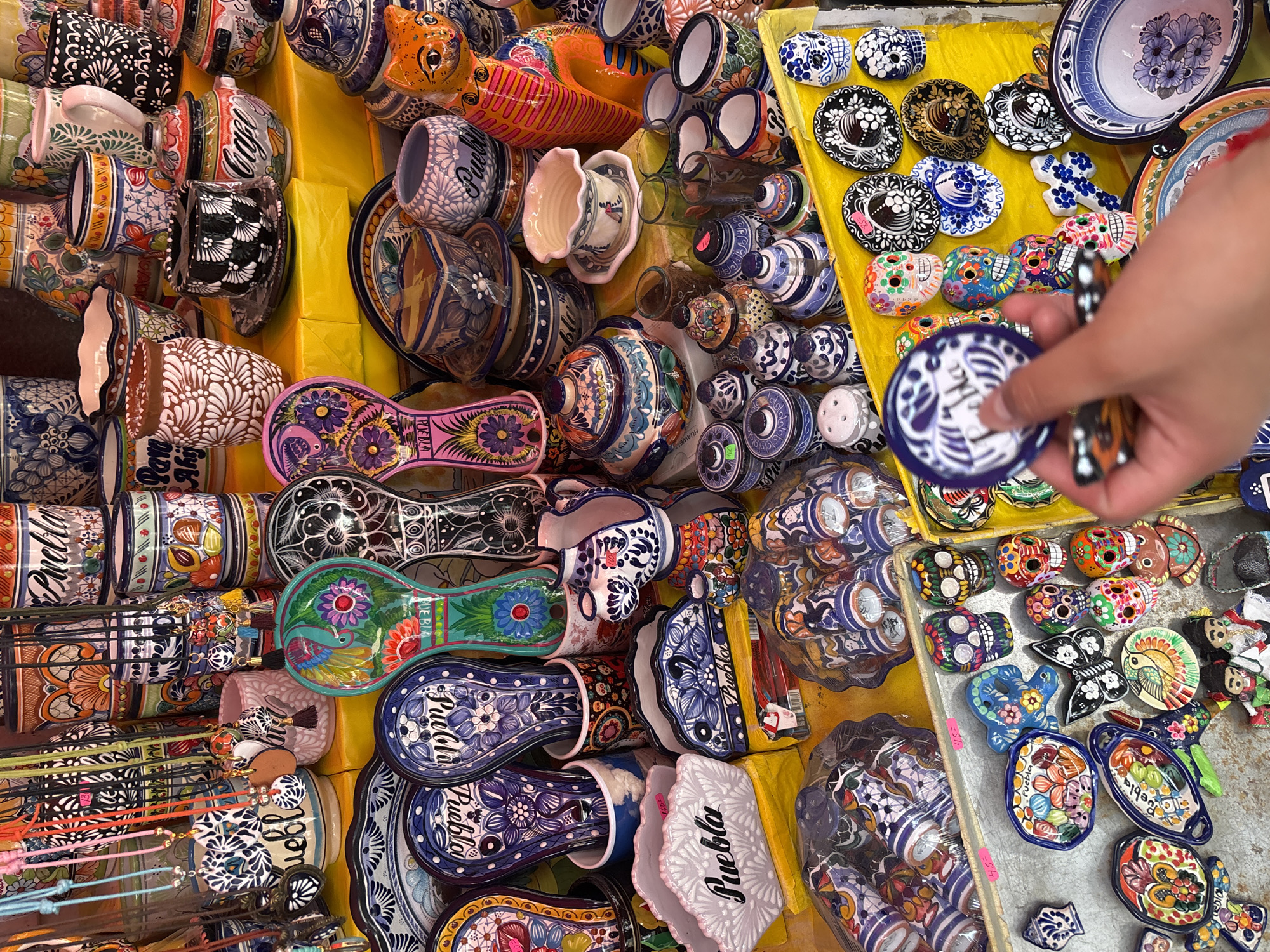 Talavera ceramics vendor displays wares at Puebla marketplace