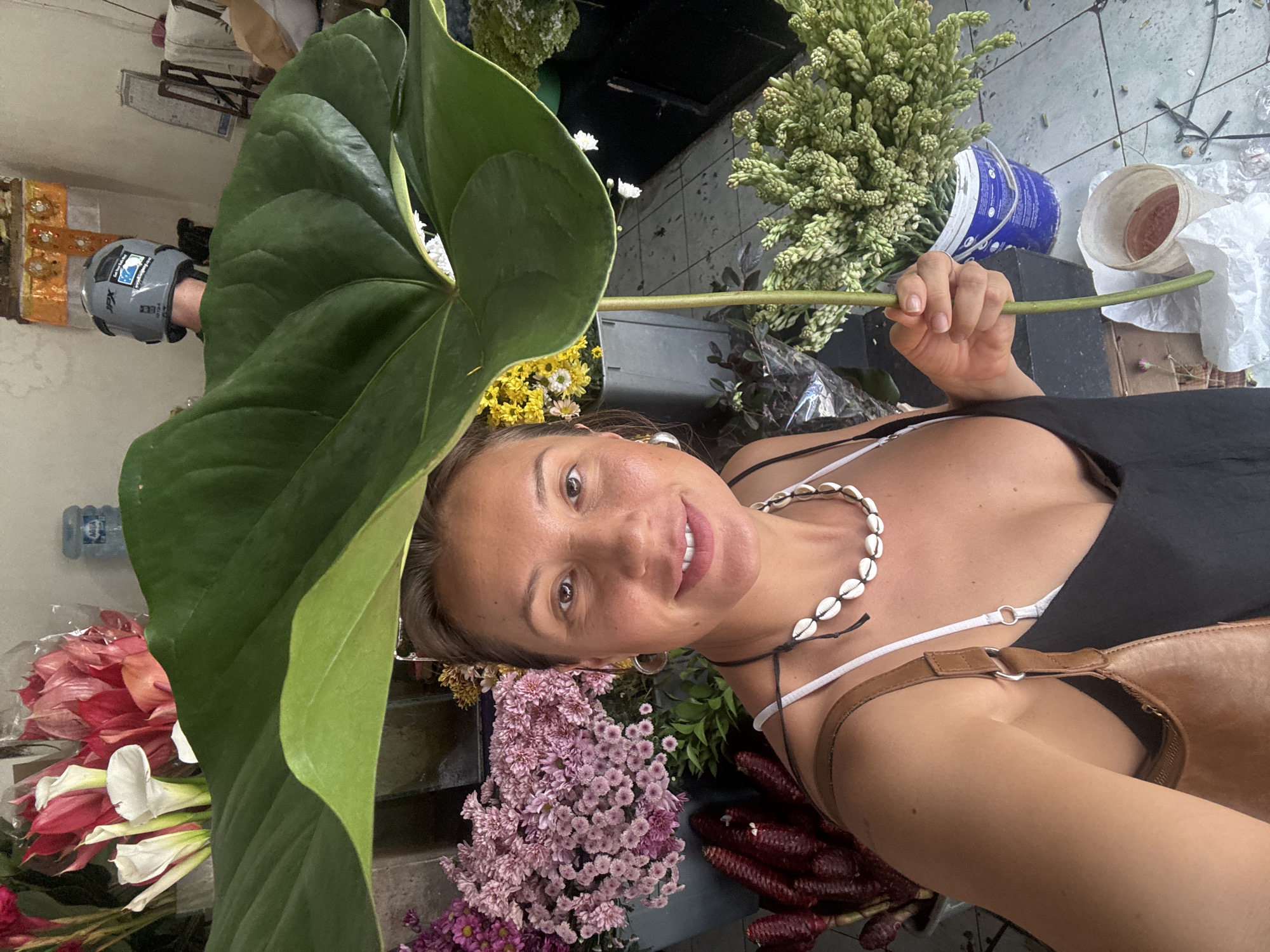 Woman arranges tropical bouquets at North Kuta flower shop