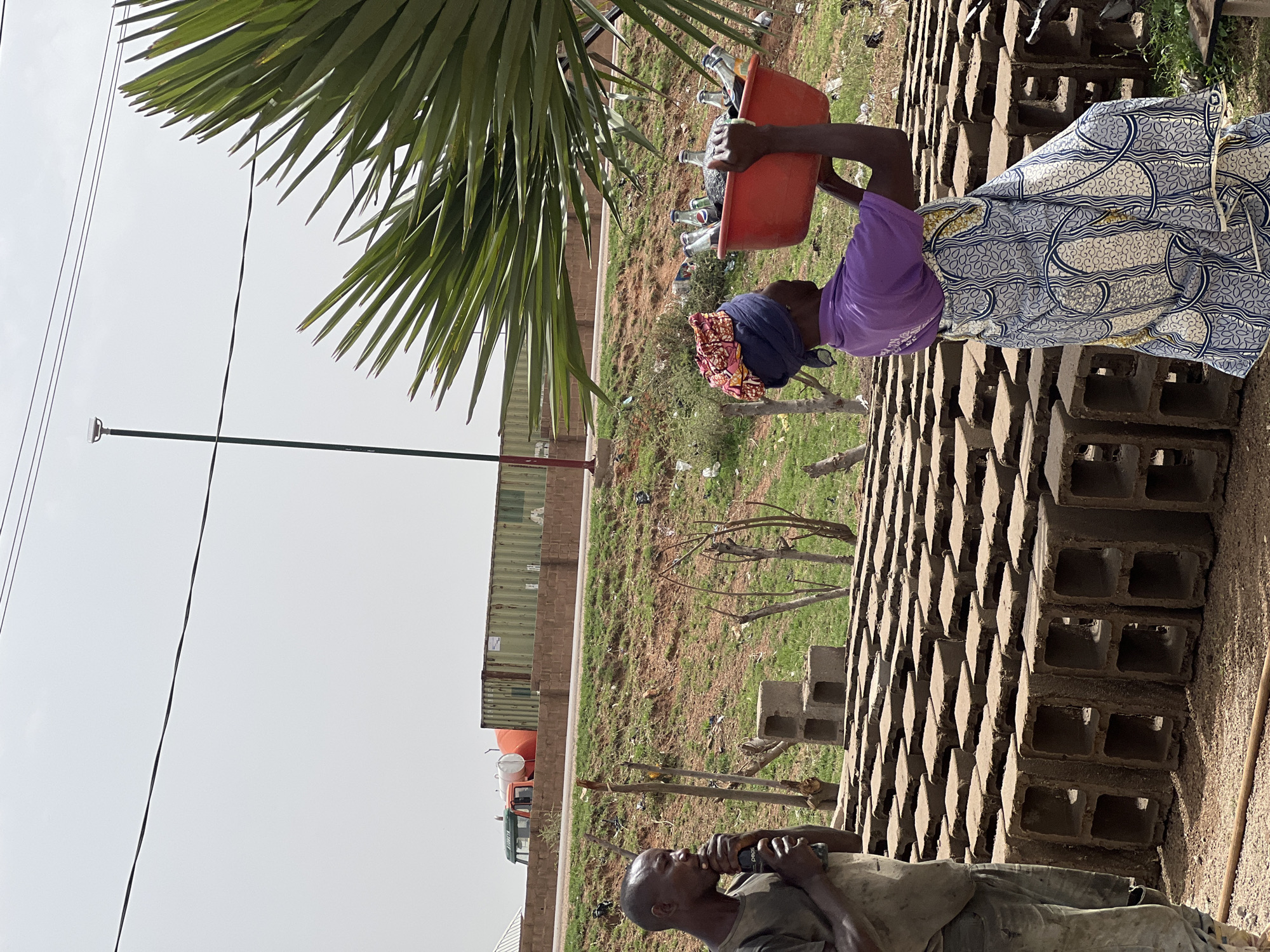 Woman carries bucket in Du, Nigeria
