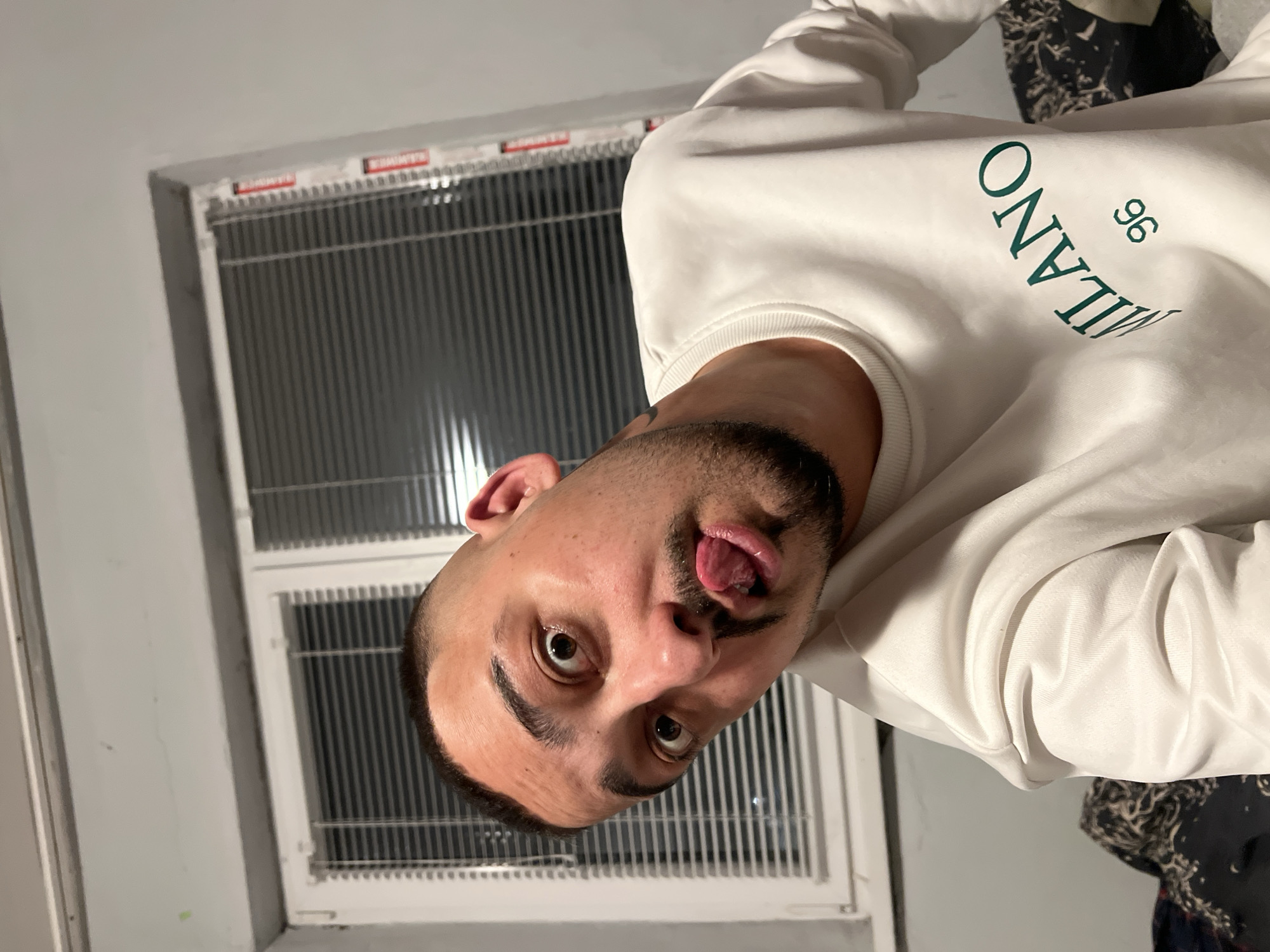 Man makes silly face in room in Shumata, Bulgaria