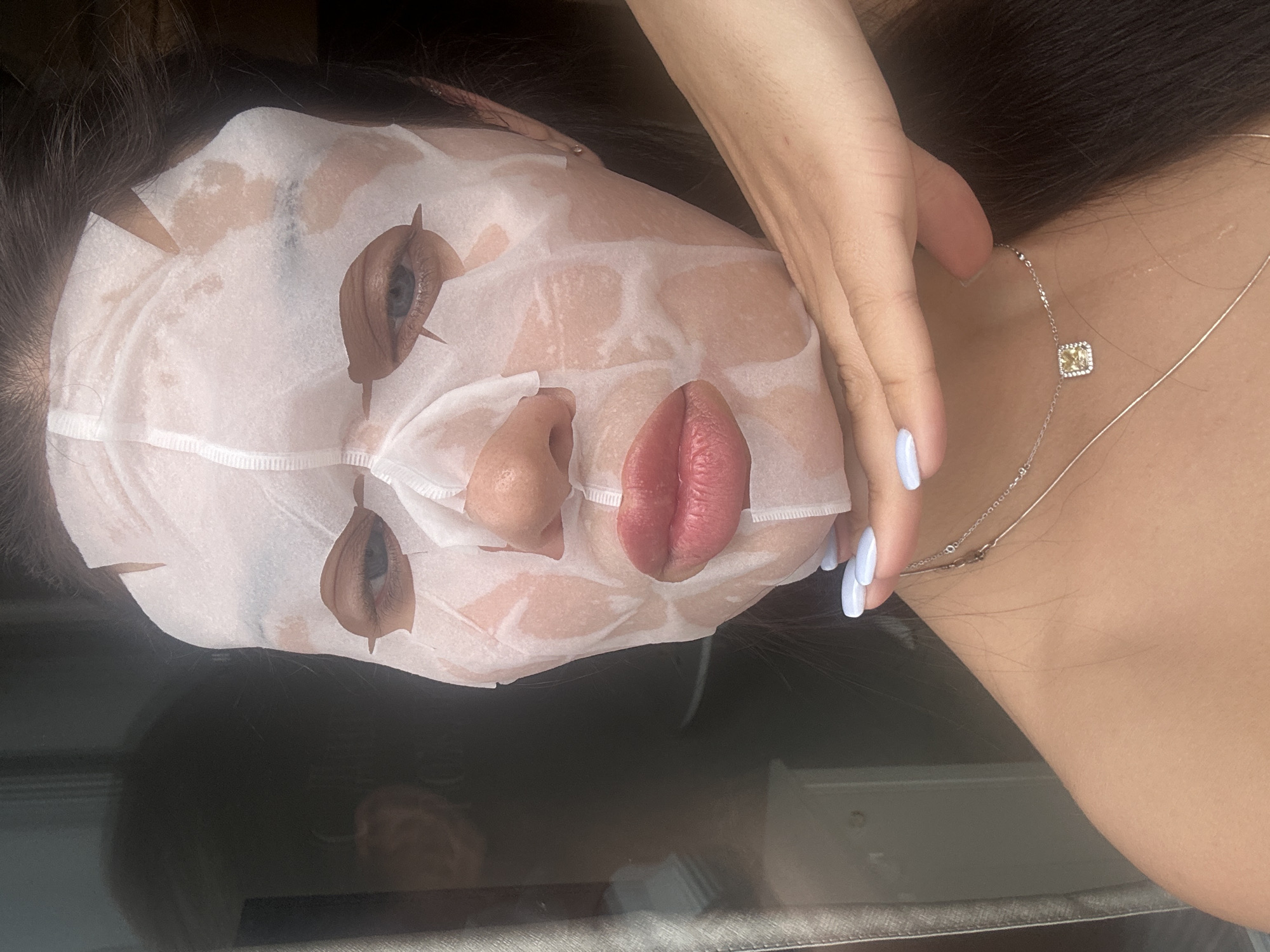 Facial treatment with white sheet mask observed in Angelovo