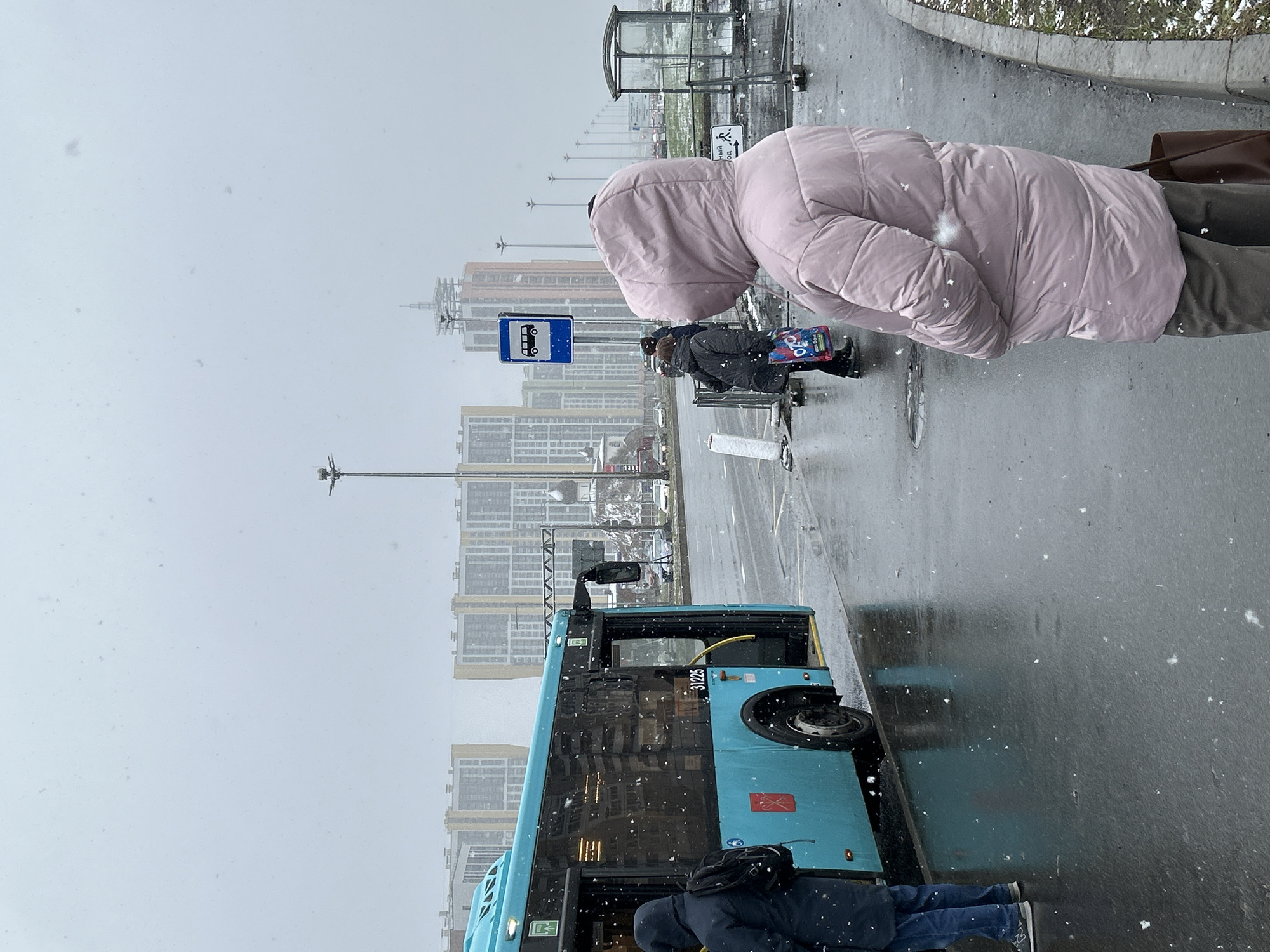 Spring snowfall blankets Saint Petersburg streets, residents continue daily routines