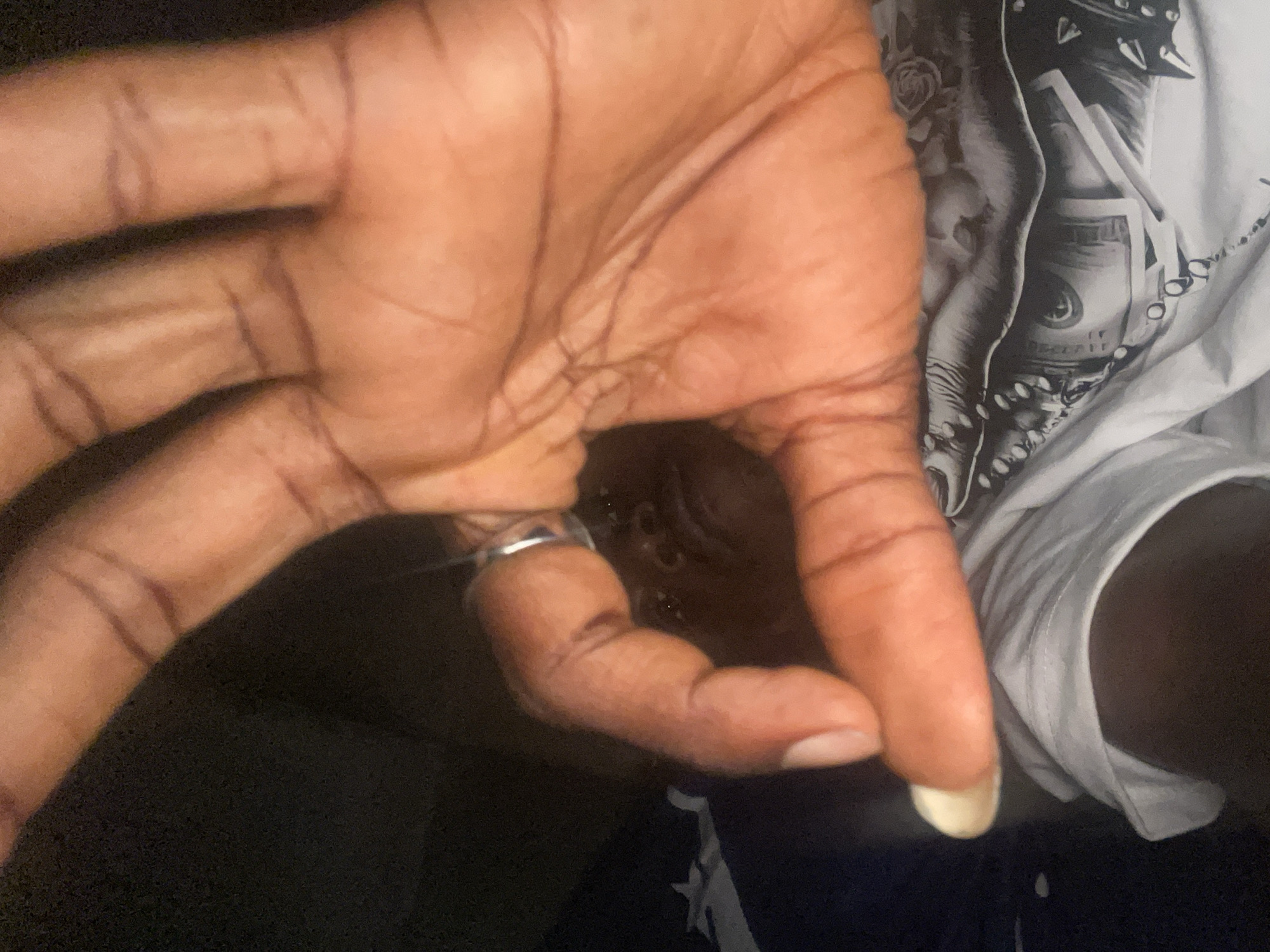 Person handles skincare lotion during evening routine in Lokoja