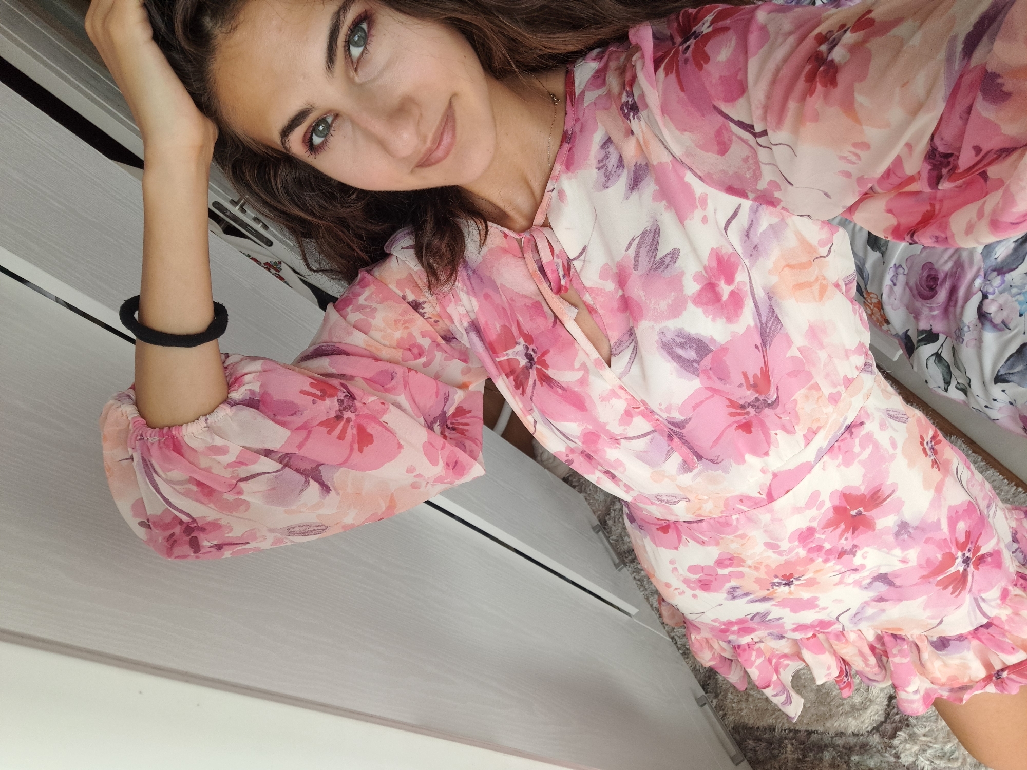 Pink dress, cozy indoor setting, and a flowering cactus