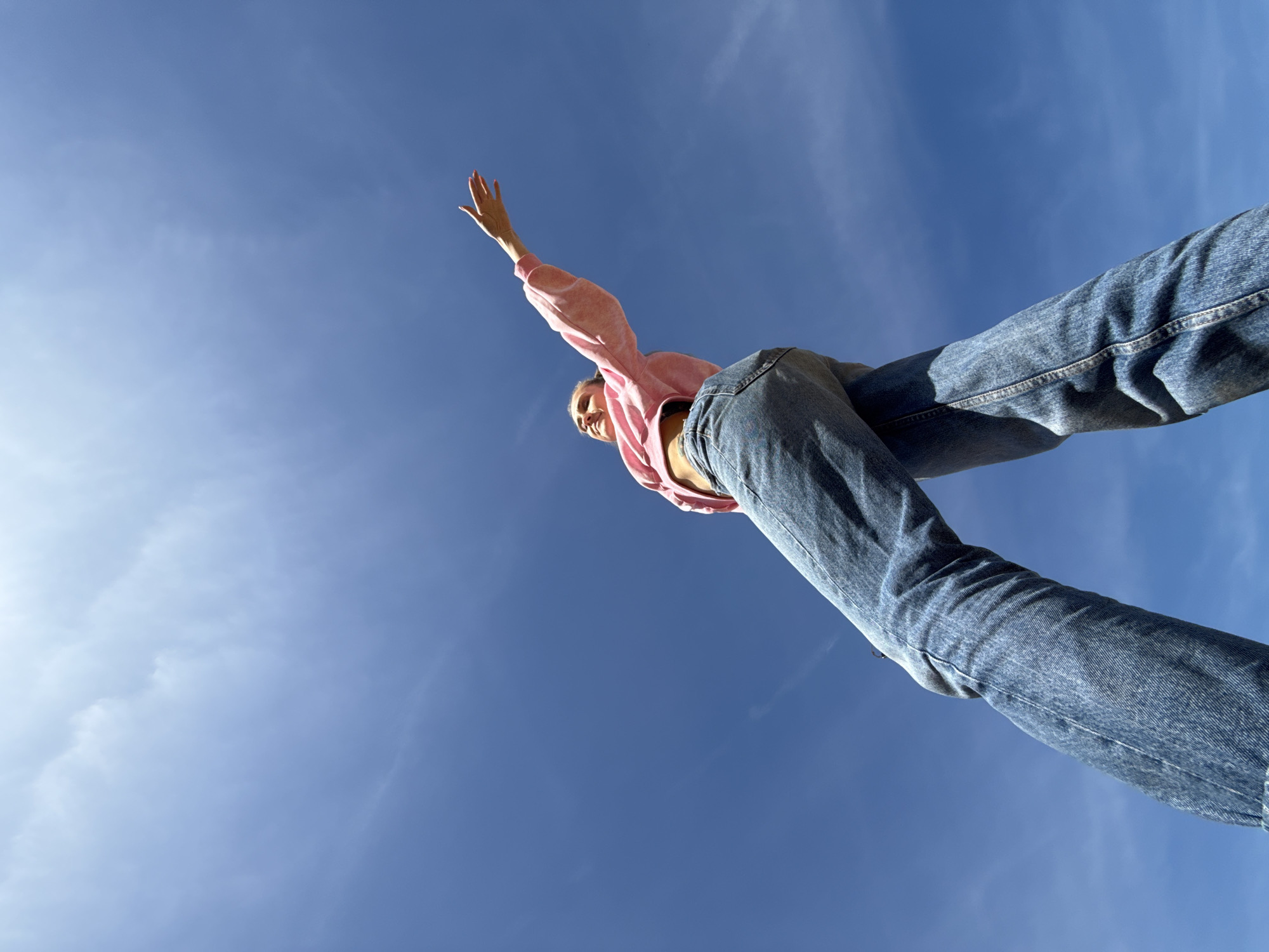 Person waves against blue sky in Chaykovsky, Russia