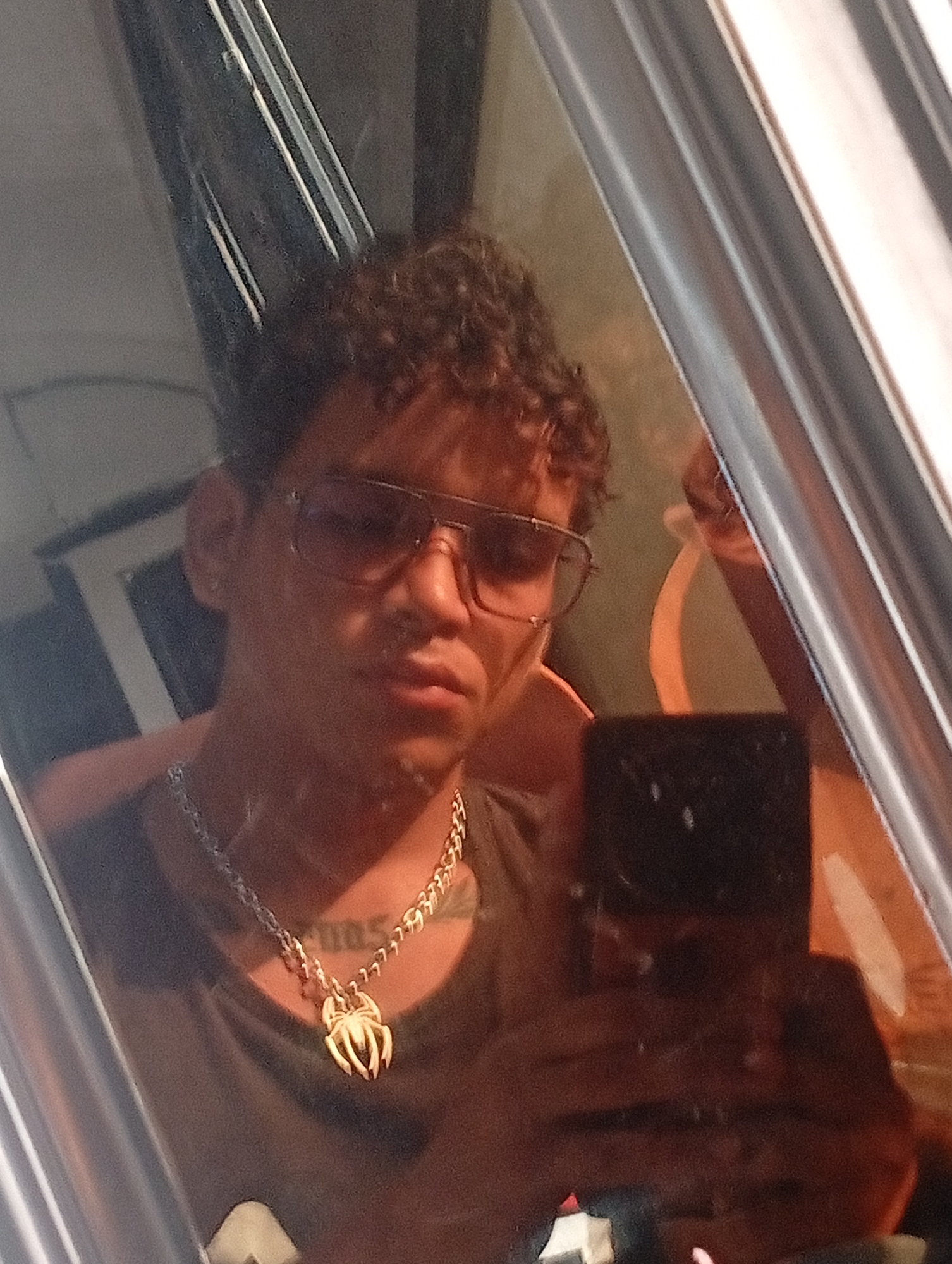 Person documents selfie session with spider pendant in Venezuela