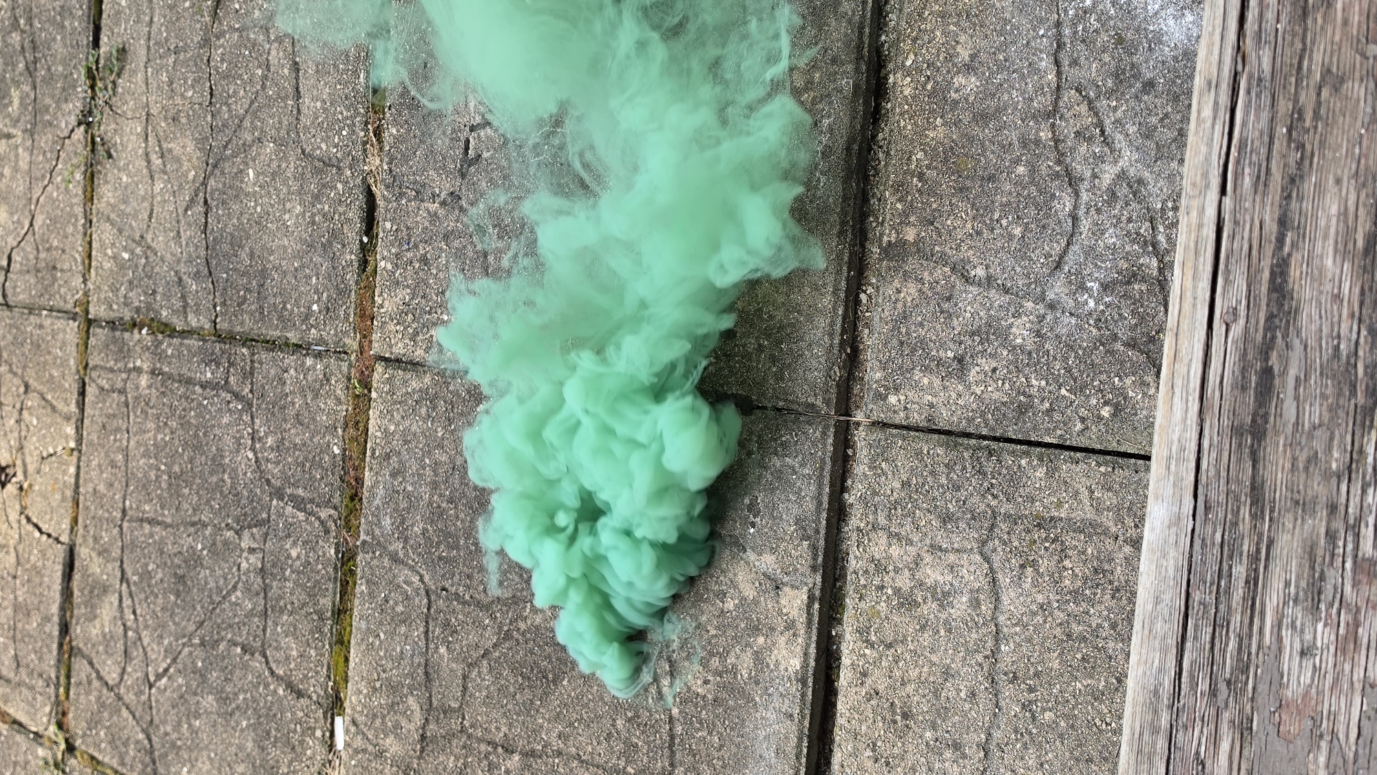 Colored smoke bombs set off on a concrete surface in Elgin