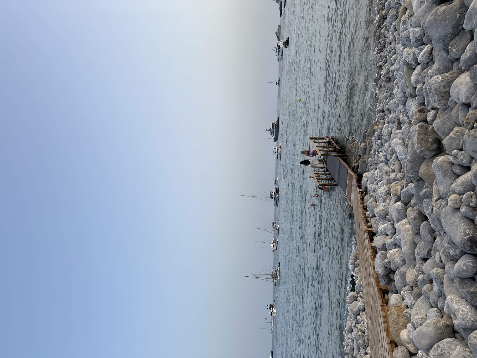 Pier and rocky shoreline at a quiet coastal spot