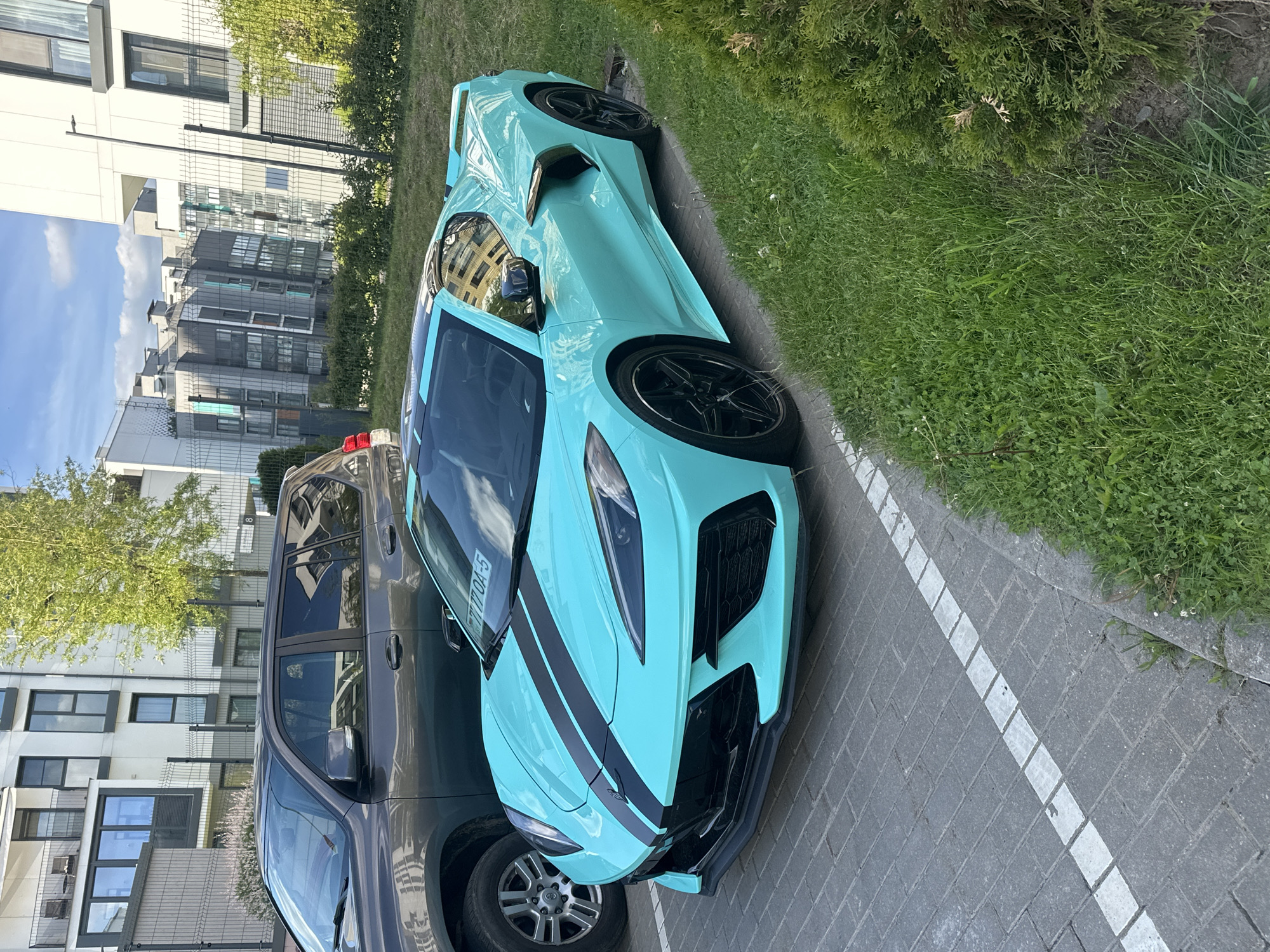 Turquoise Corvette C8 and vehicles documented in Belarus parking area