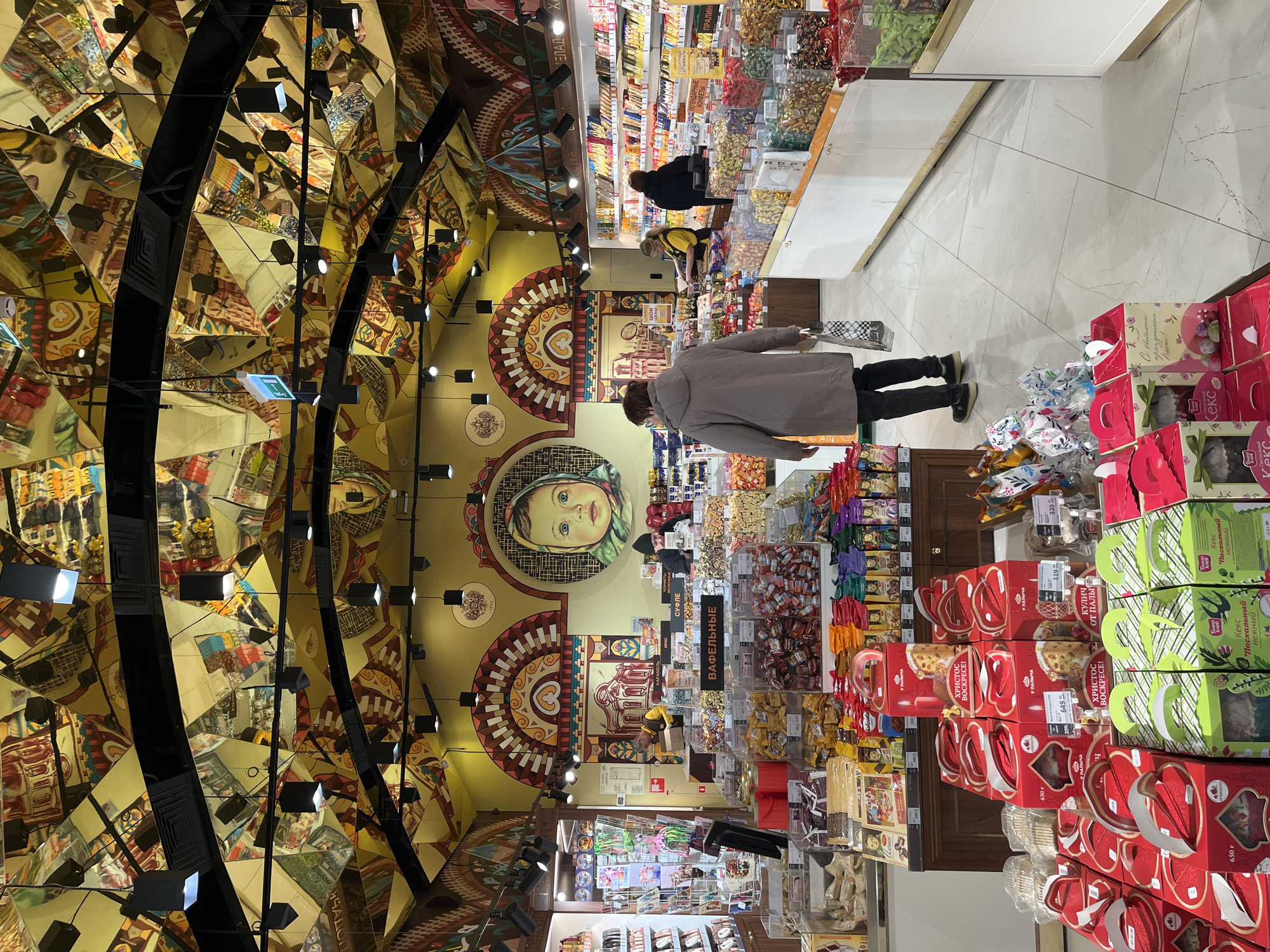 Moscow shoppers document ornate Eliseevsky store and Arbat Street scenes