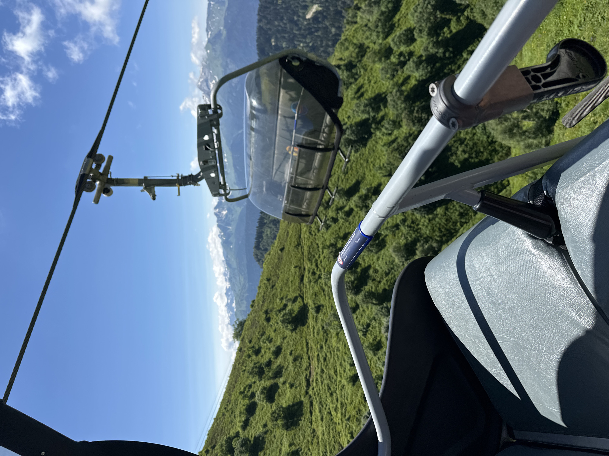 Summer ski lift ride through Estosadok's green mountain terrain