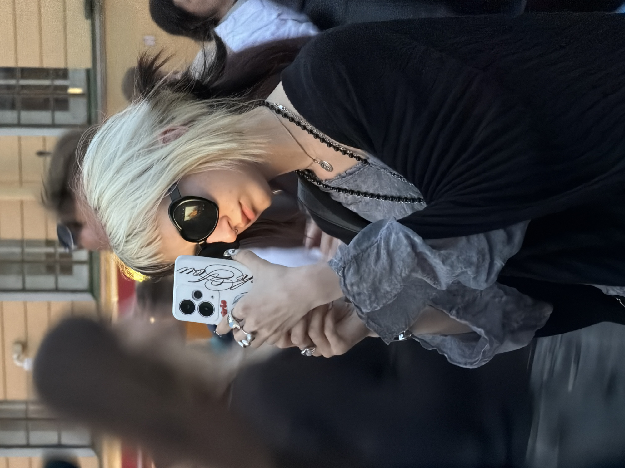 Selfie in sunglasses and a ruffled grey layered top