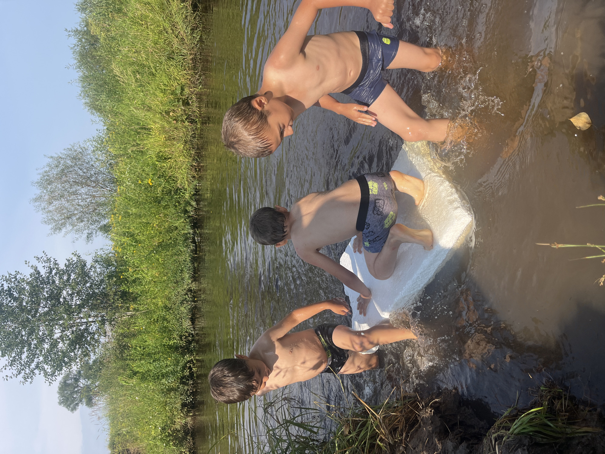 Outdoor summer play: river, hammock, and mud puddles