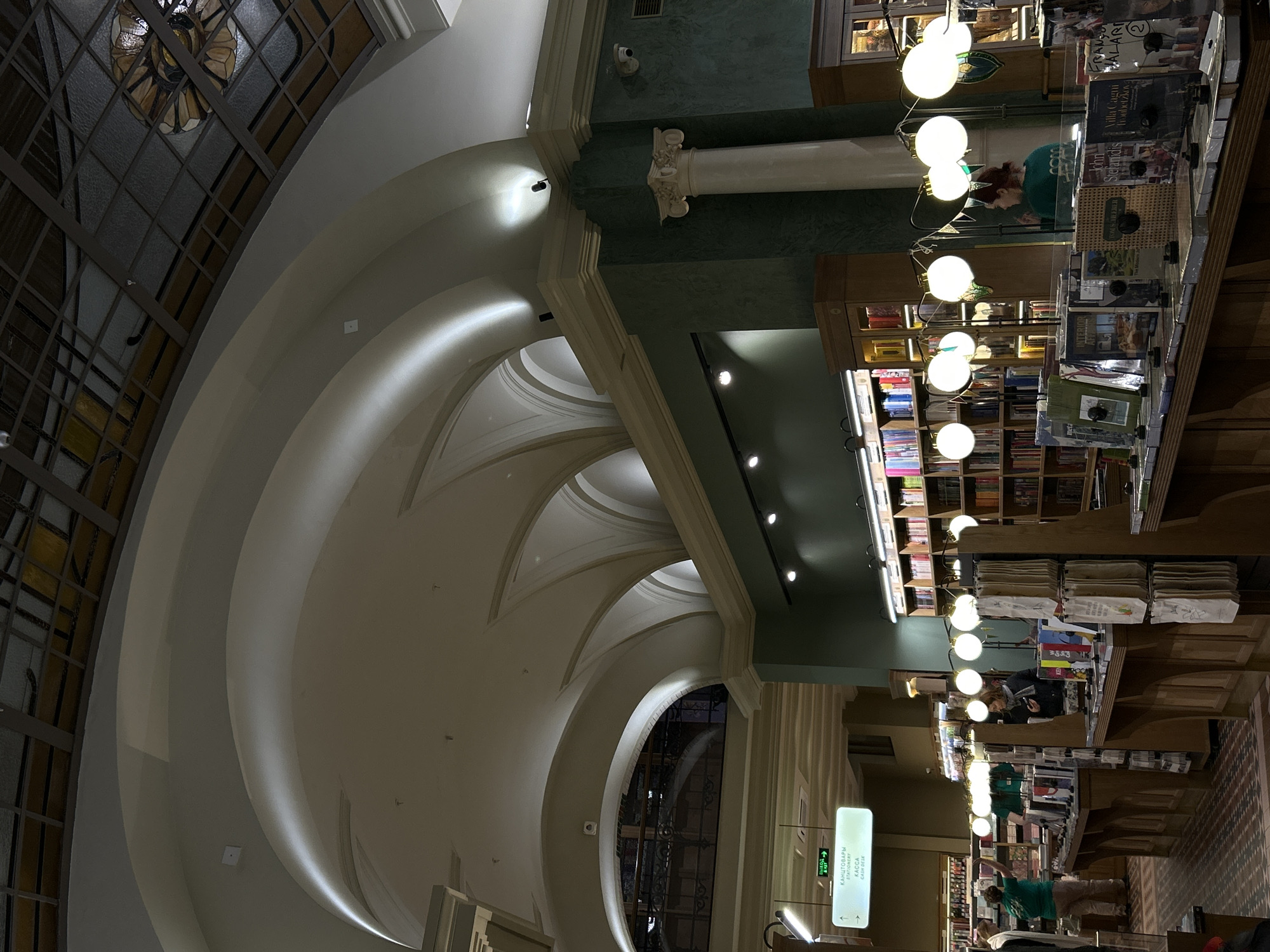 Woman browses books in grand Saint Petersburg bookstore