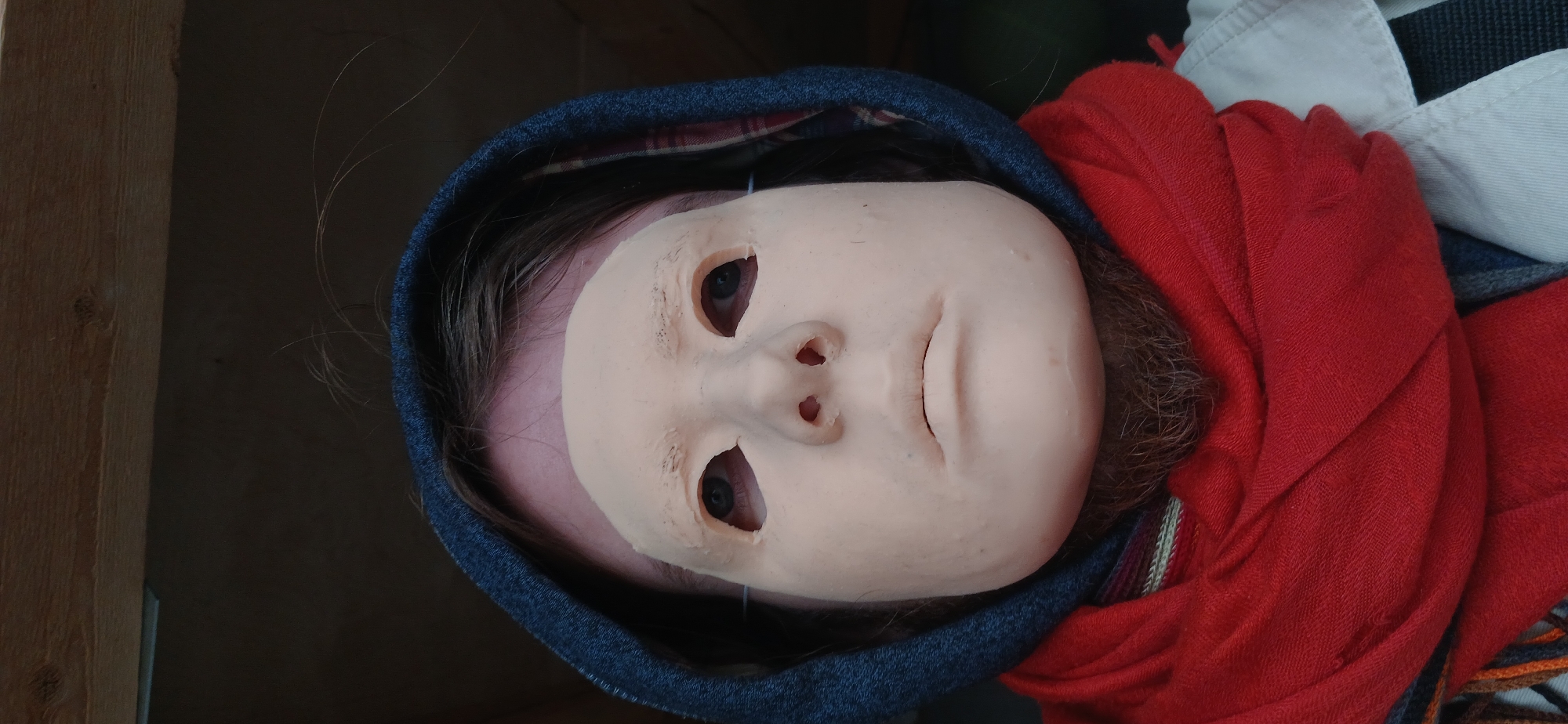 Masked individual observed behind glass holding device
