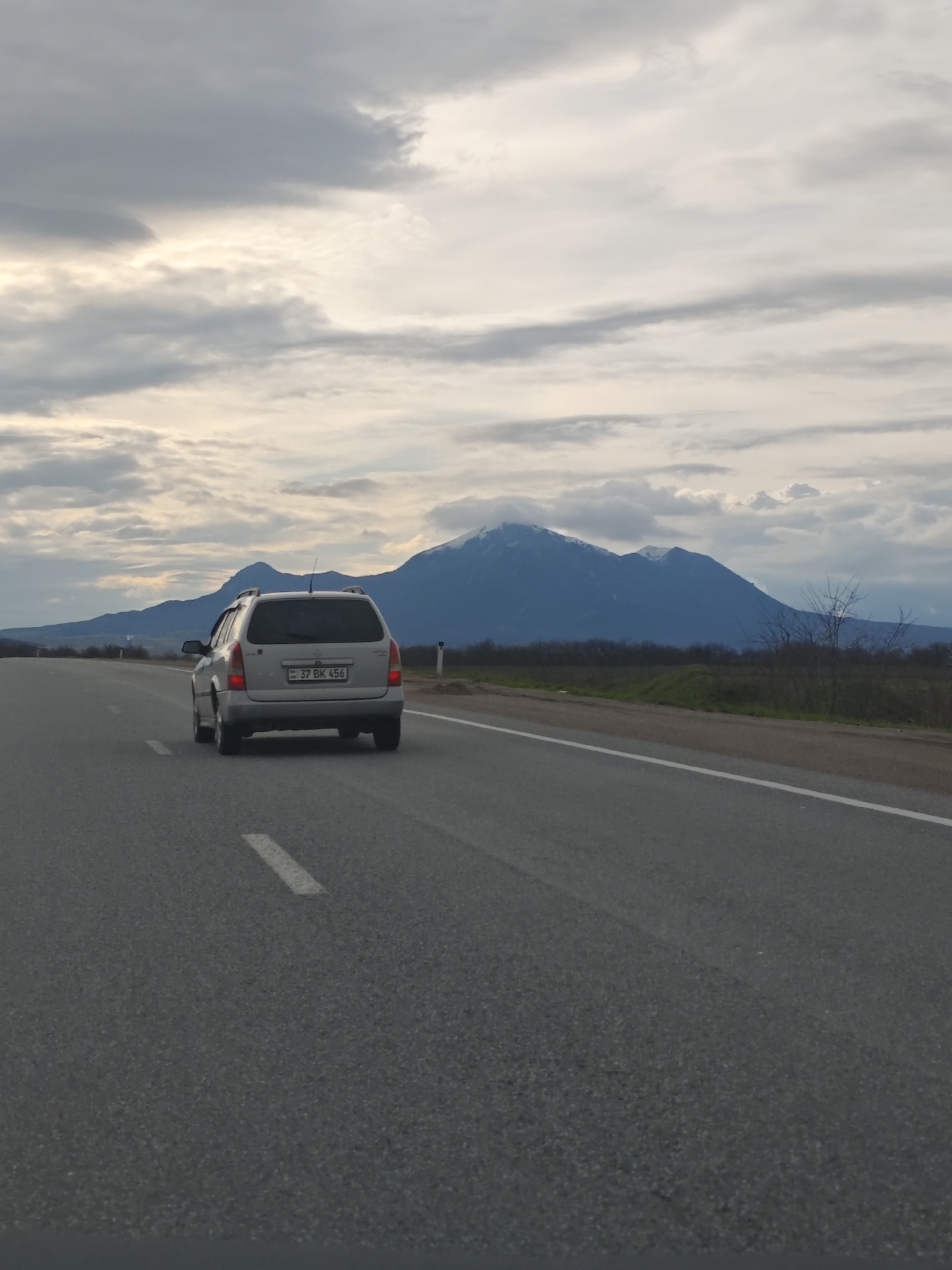 Silver station wagon travels rural road near Konstantinovskaya, Russia