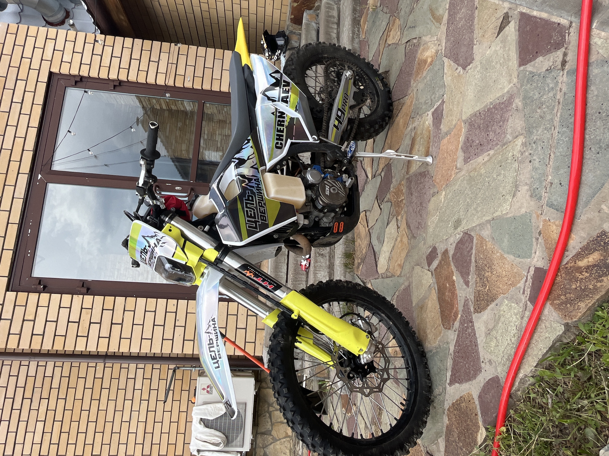 Dirt bike documented in Russian residential backyard garden