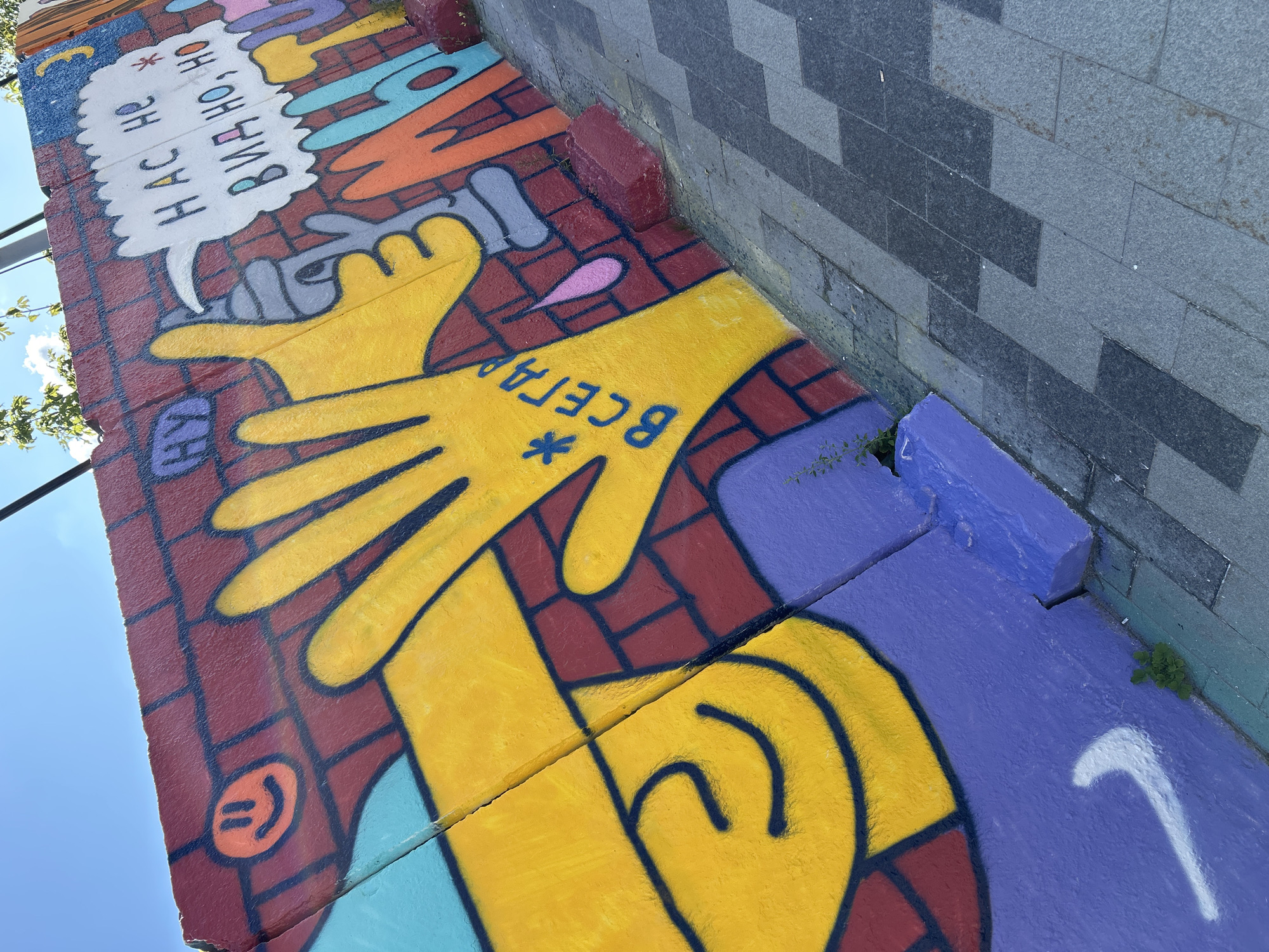 Exploring a brick-and-mural arts district on a summer morning