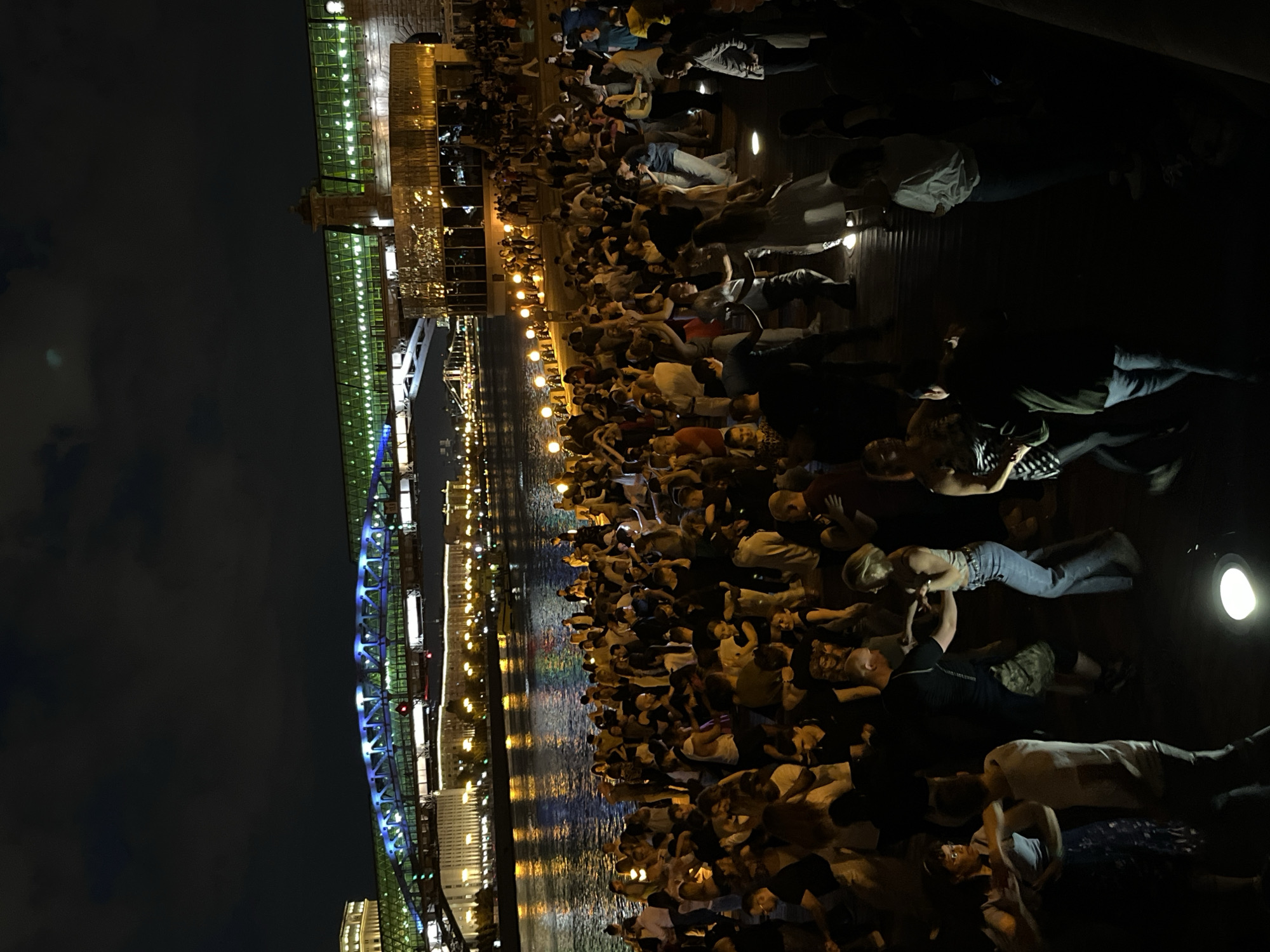 Evening crowds gather along Moscow river embankment for dining