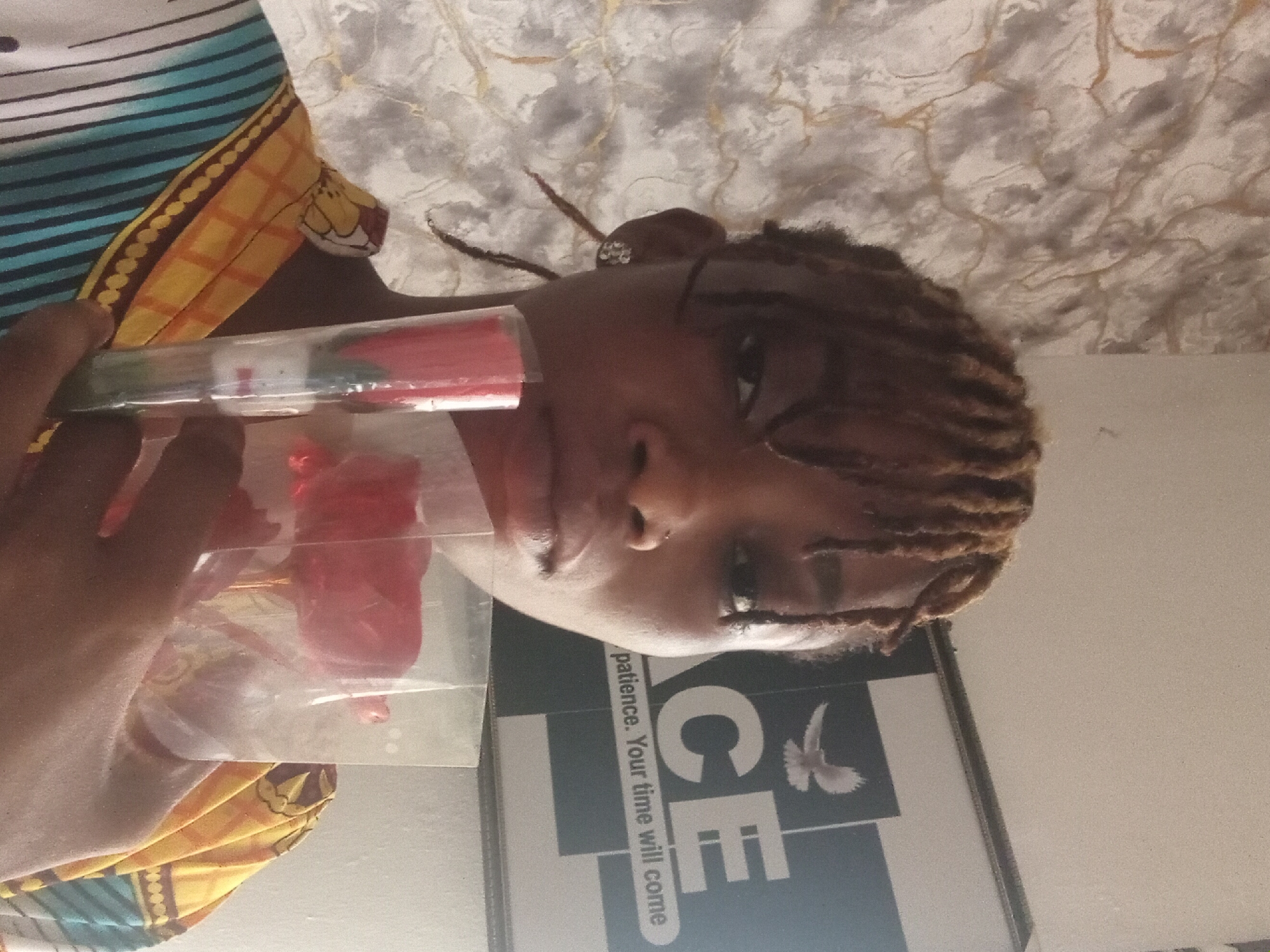 Woman poses with flowers, beauty products in Shagamu home