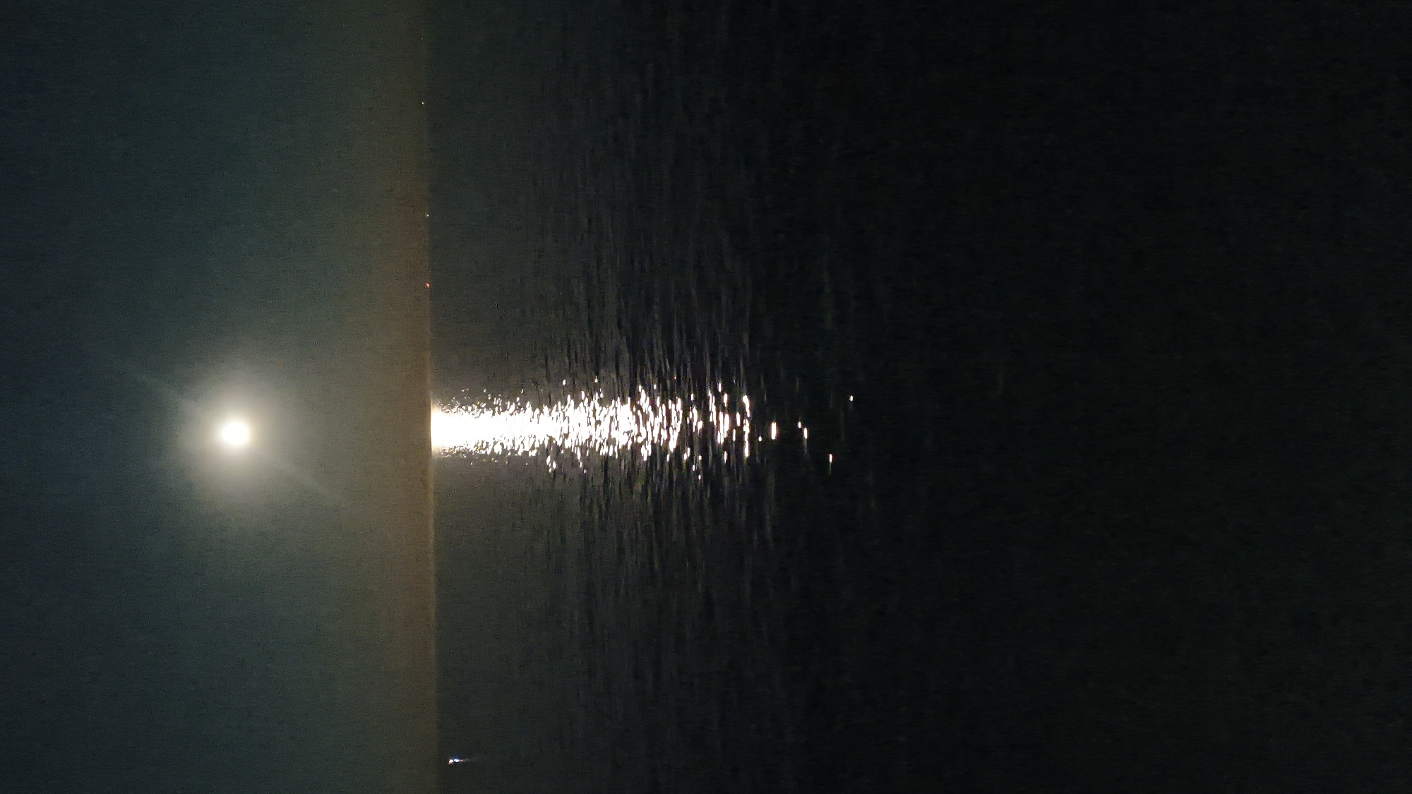 Full moon reflection over a calm nighttime sea
