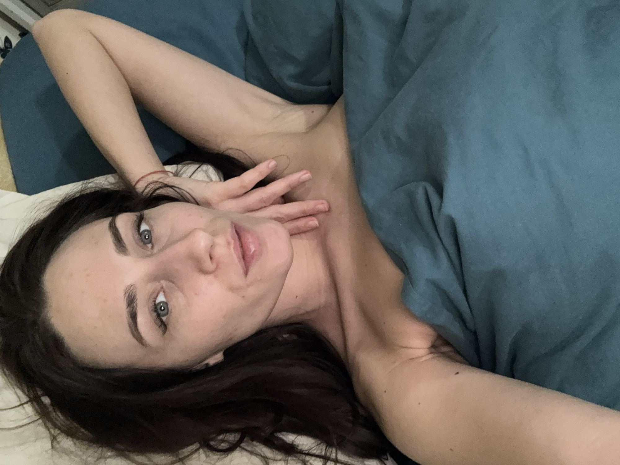 Woman rests on bed in Saint Petersburg apartment