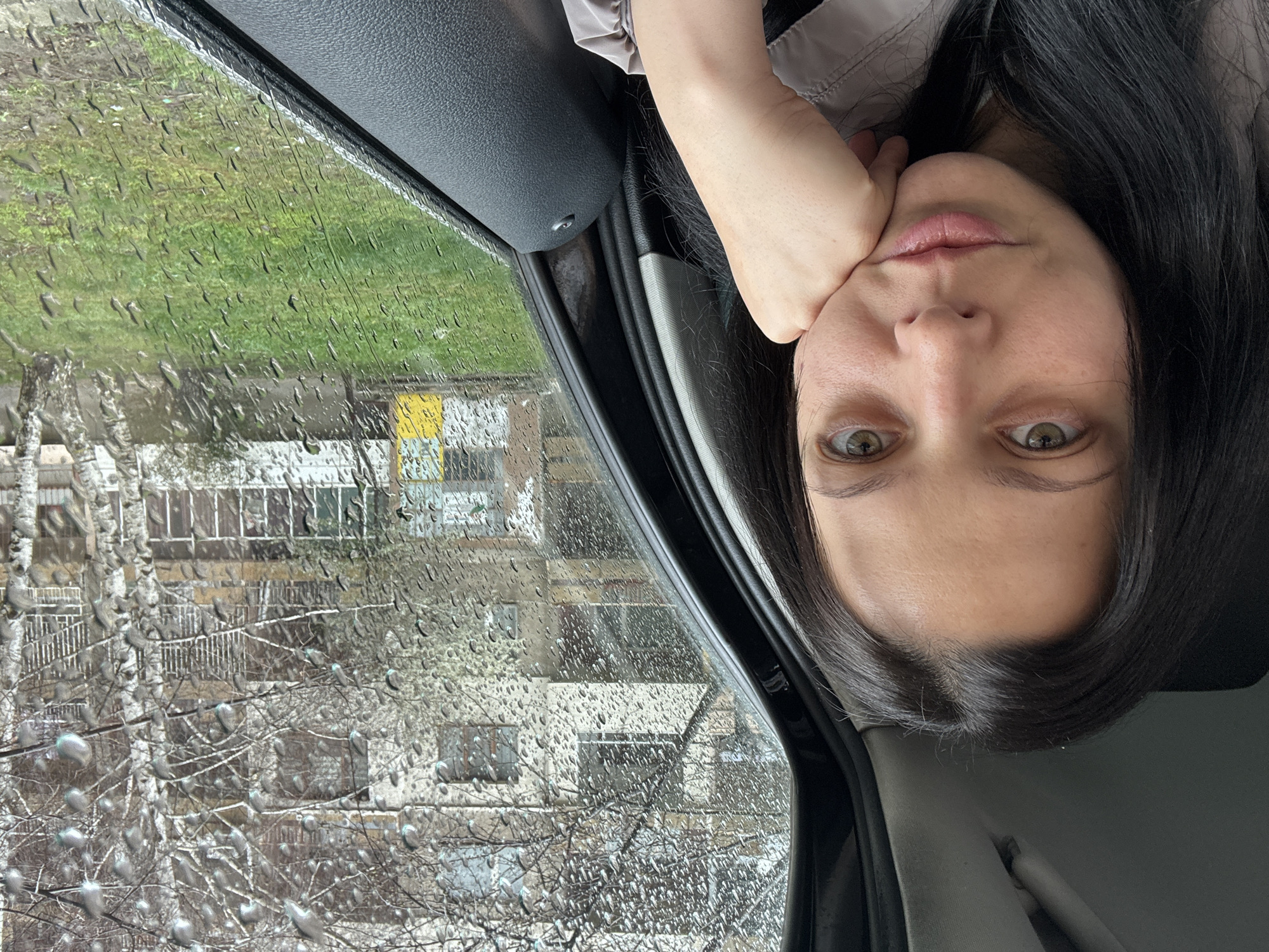 Woman in car during rainy day in Pernik, Bulgaria