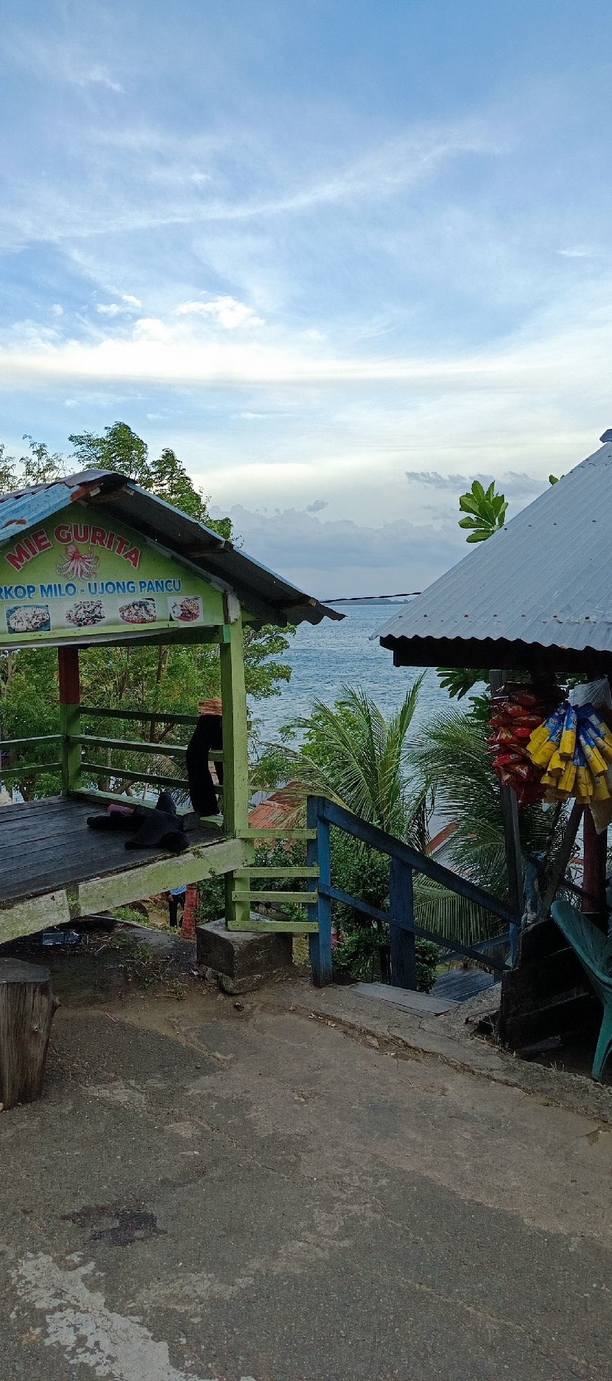 Quiet coastal stop in Lampageu, Indonesia, with food stalls and sea views