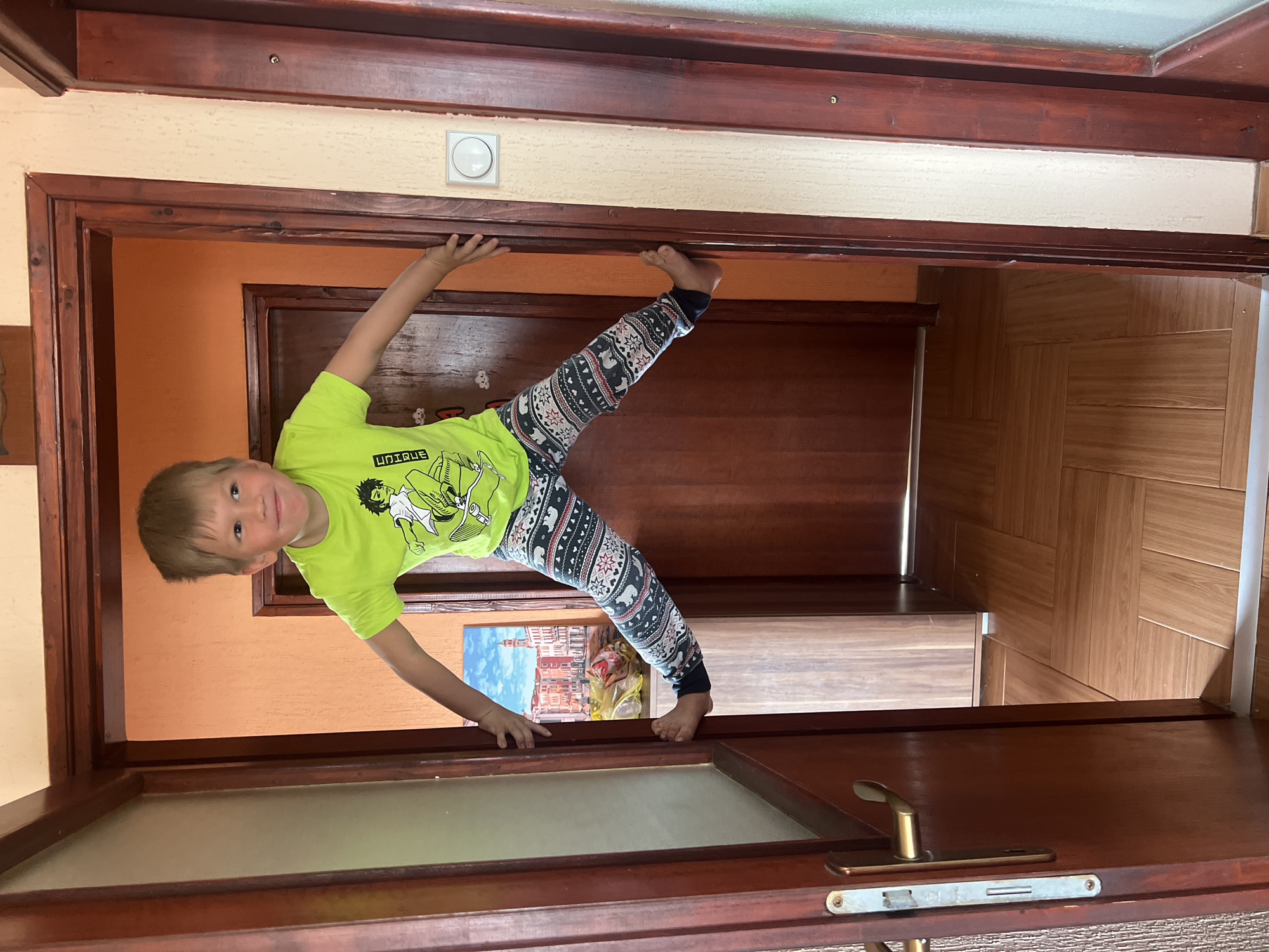 Boy performs handstand in doorway in Podgorica