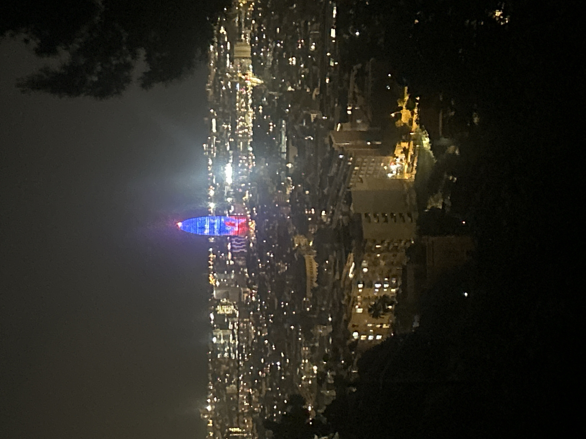 Barcelona building illuminated in blue and red at night