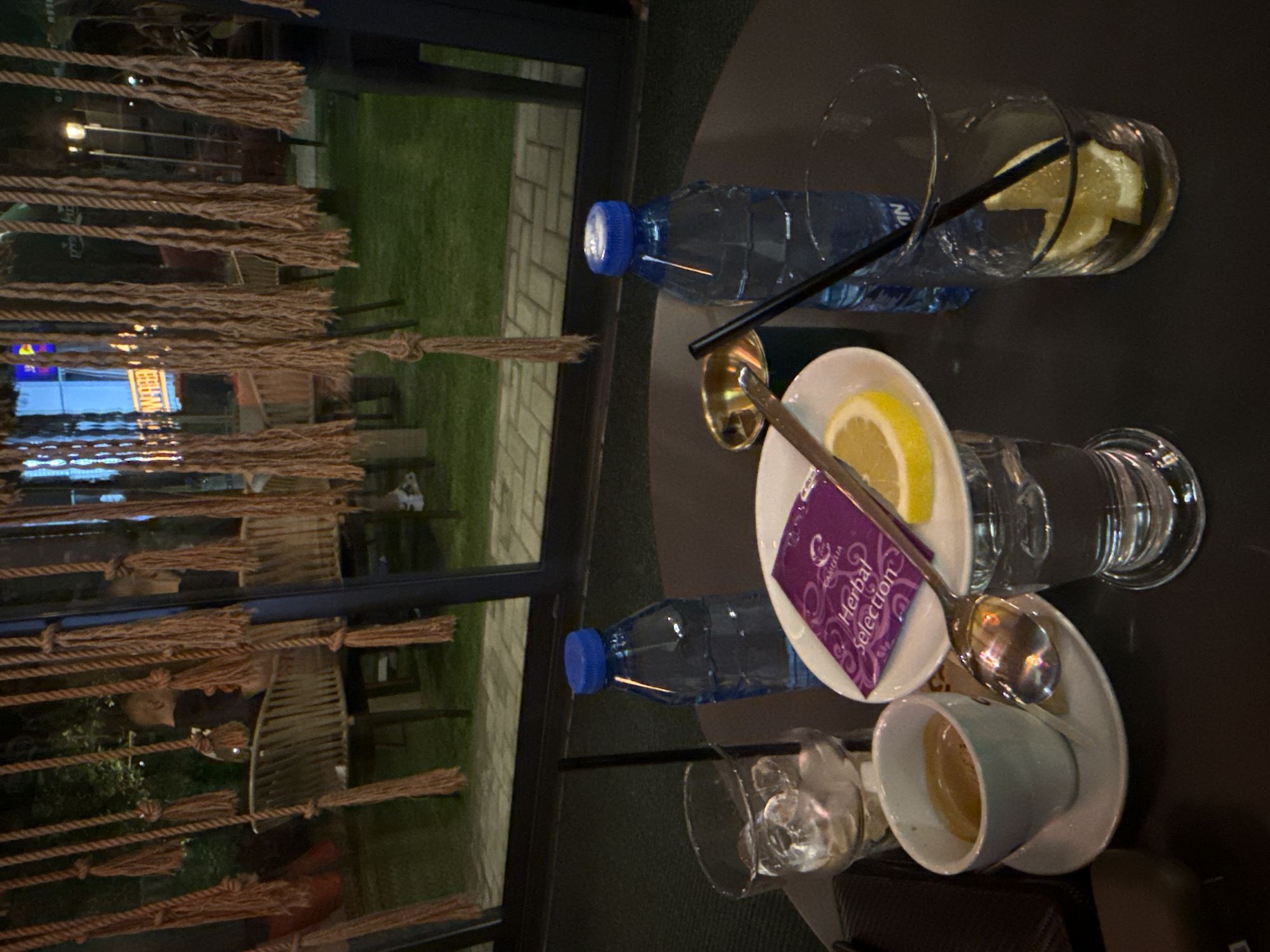 Evening cafe scene features ornate mosaic lamps in Yambol