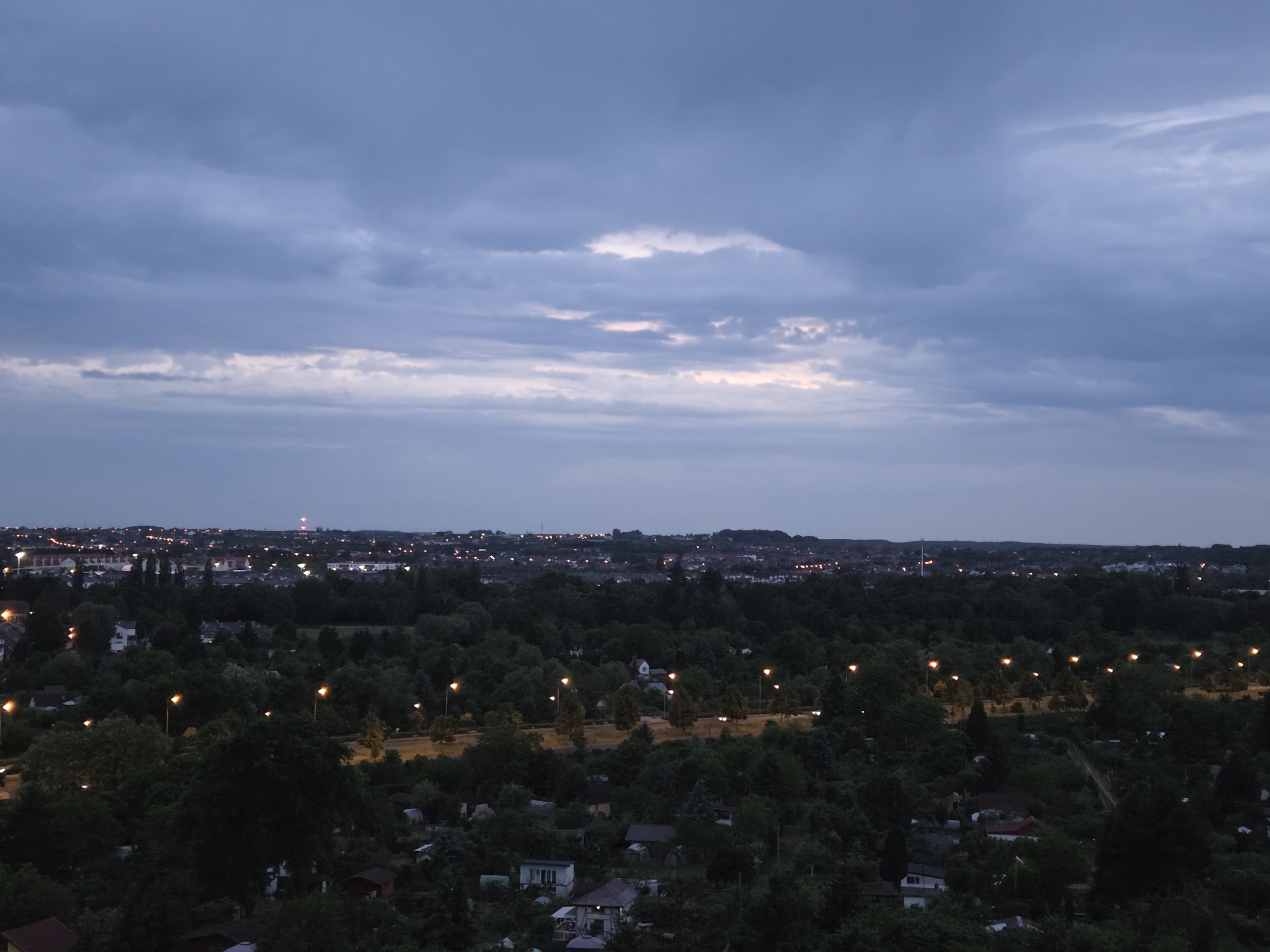 Dusk-to-night transition captured over Szczecin cityscape from elevated viewpoint