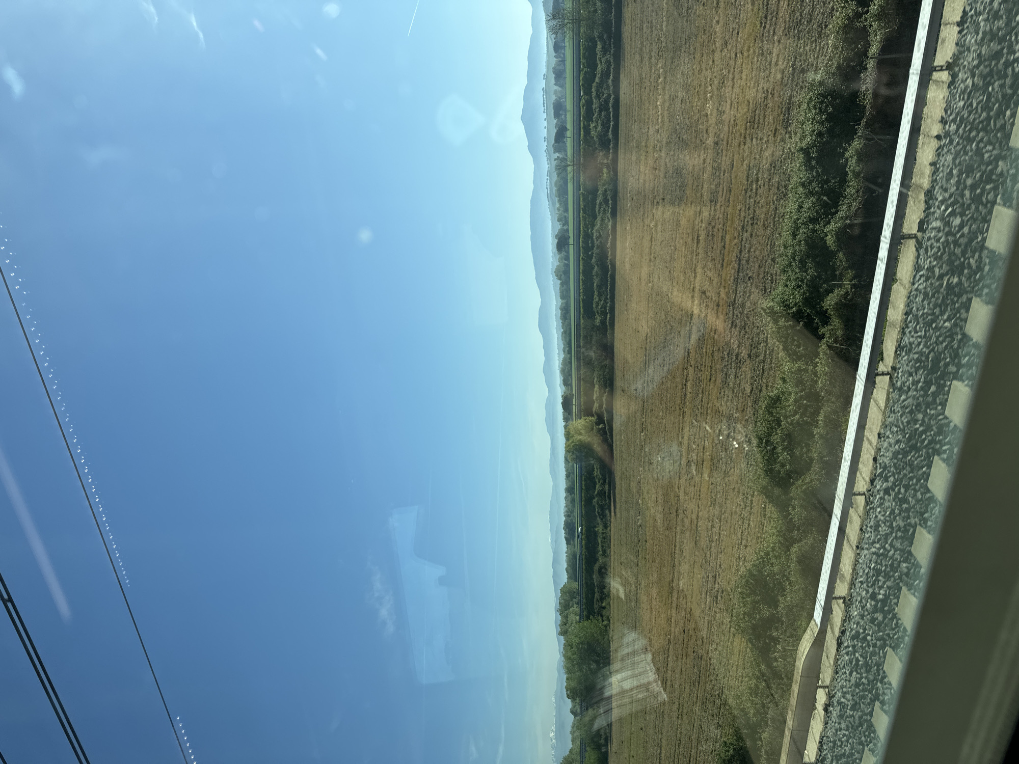 Train passenger photographs mountain landscape near Rome
