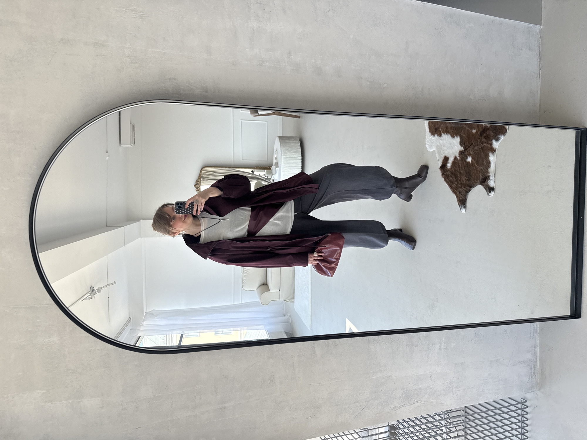 Woman takes mirror selfie indoors in Izhevsk, Russia