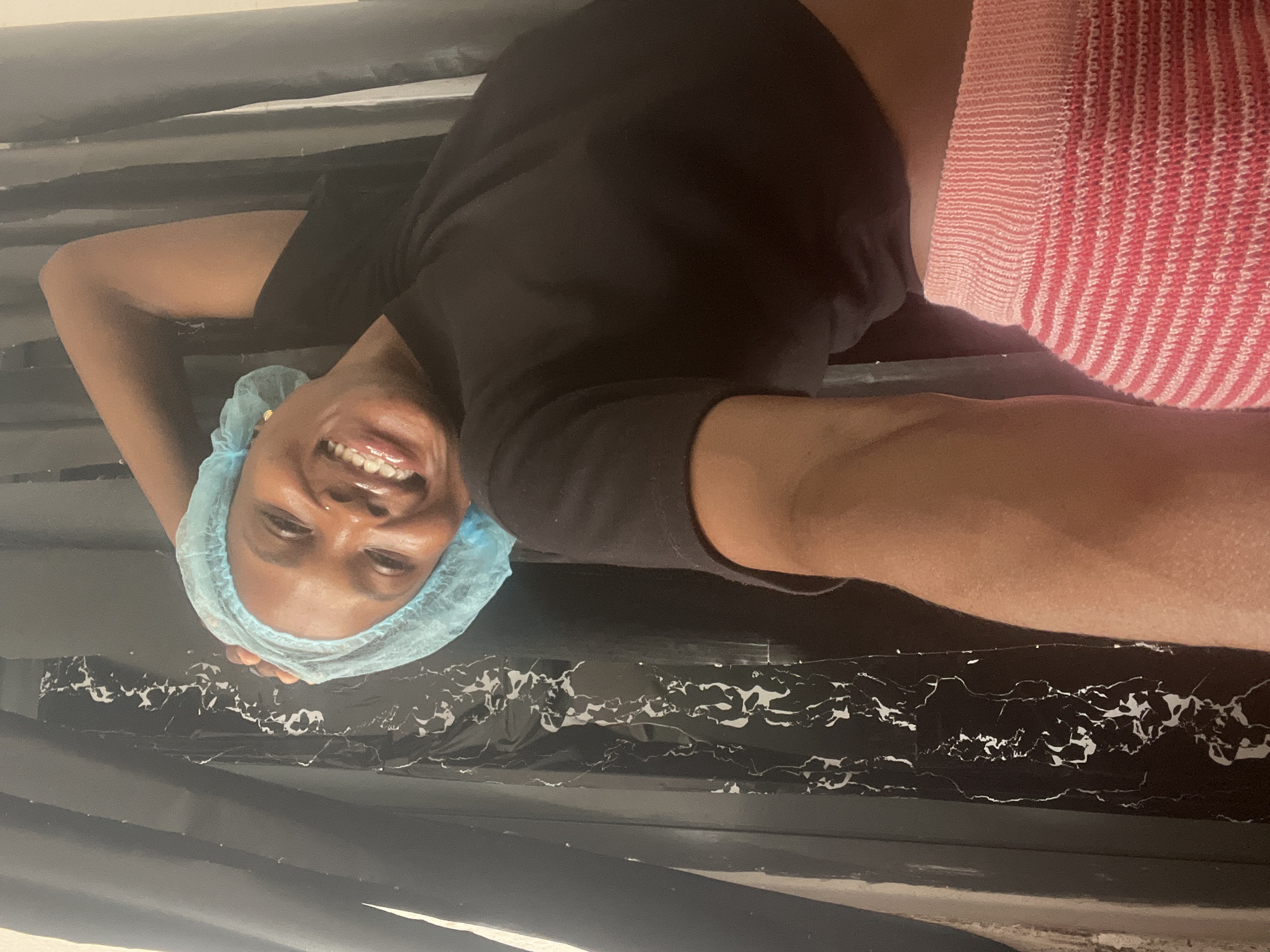 Woman in surgical cap poses playfully during Lekki photoshoot