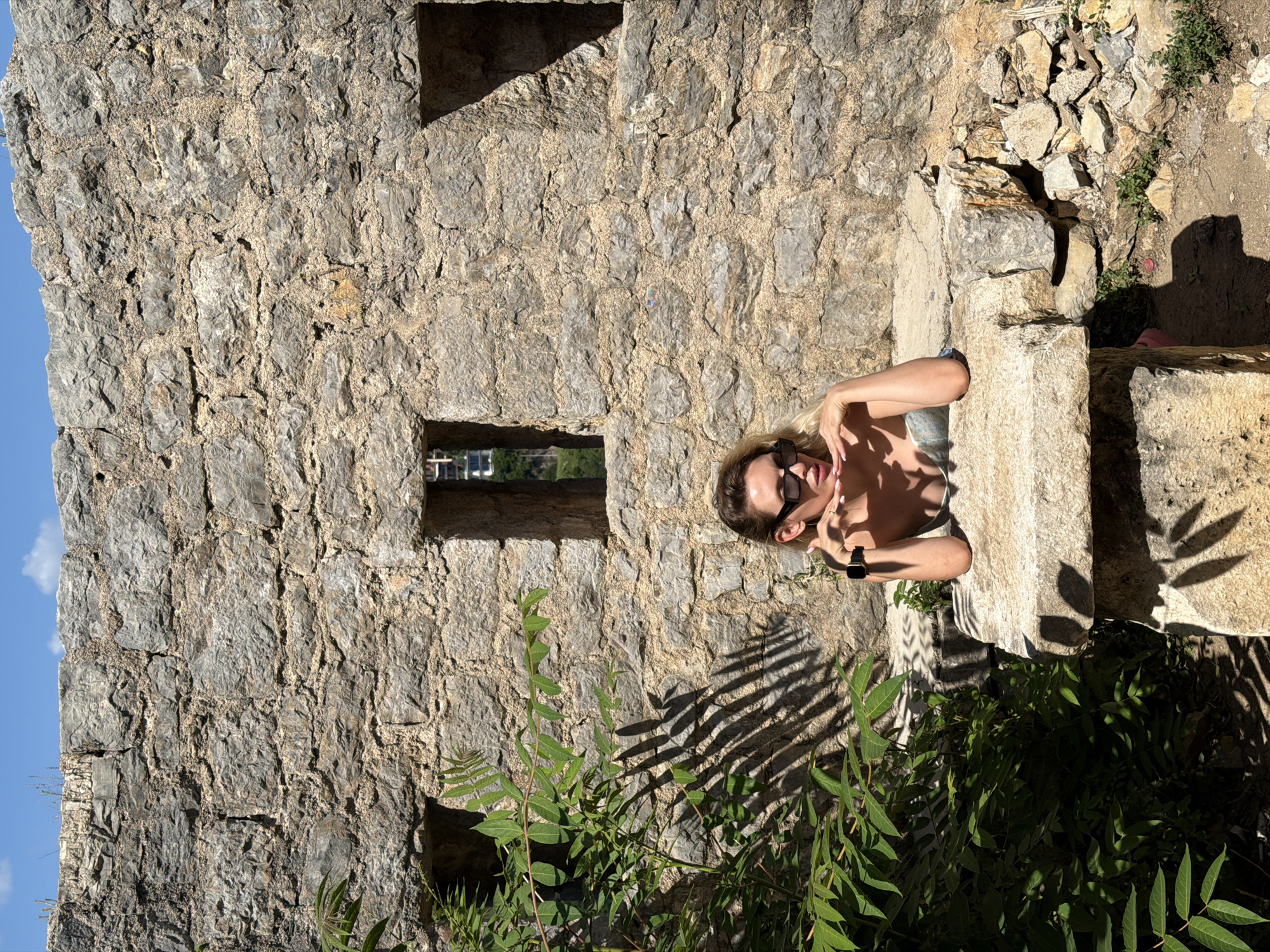 Woman photographs tourist sites around Budva, Montenegro